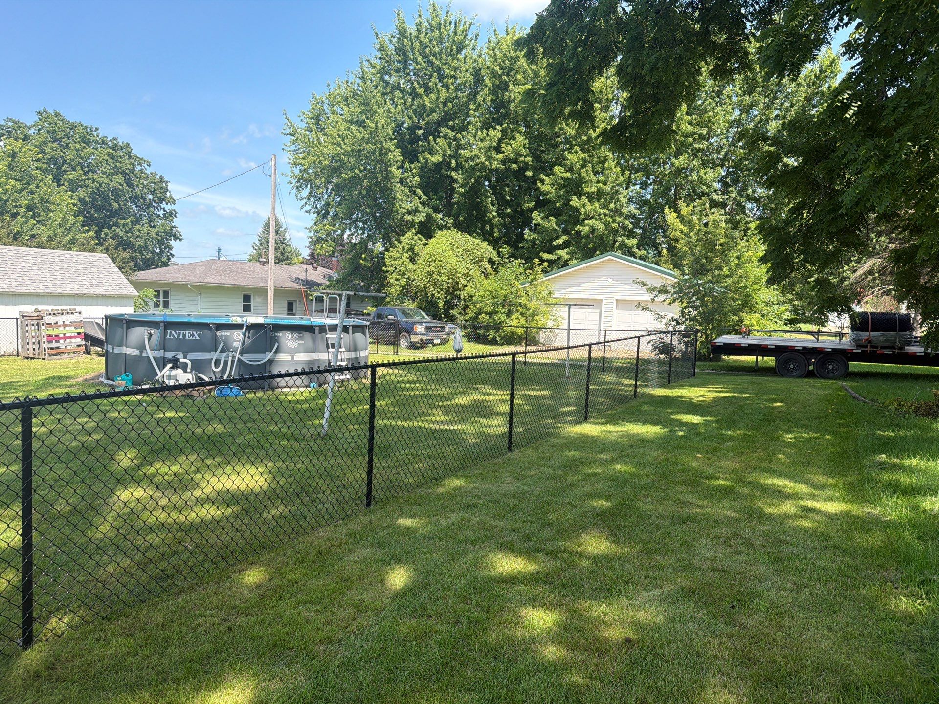 Black Chain Link Backyard Fence Installation in Tripoli, IA by Perfect Picket Fence and Stain