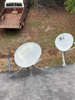 Satellite dishes mounted on architectural asphalt shingle roof