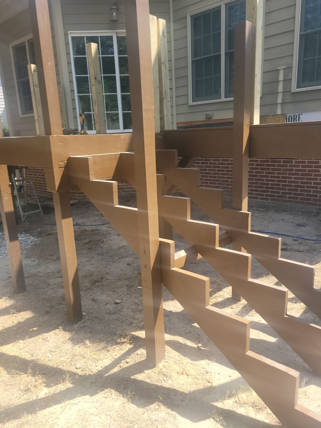 Fuquay-Varina Outdoor Upgrade – Composite Deck & Paved Landing by Elite Remodeling and Design LLC