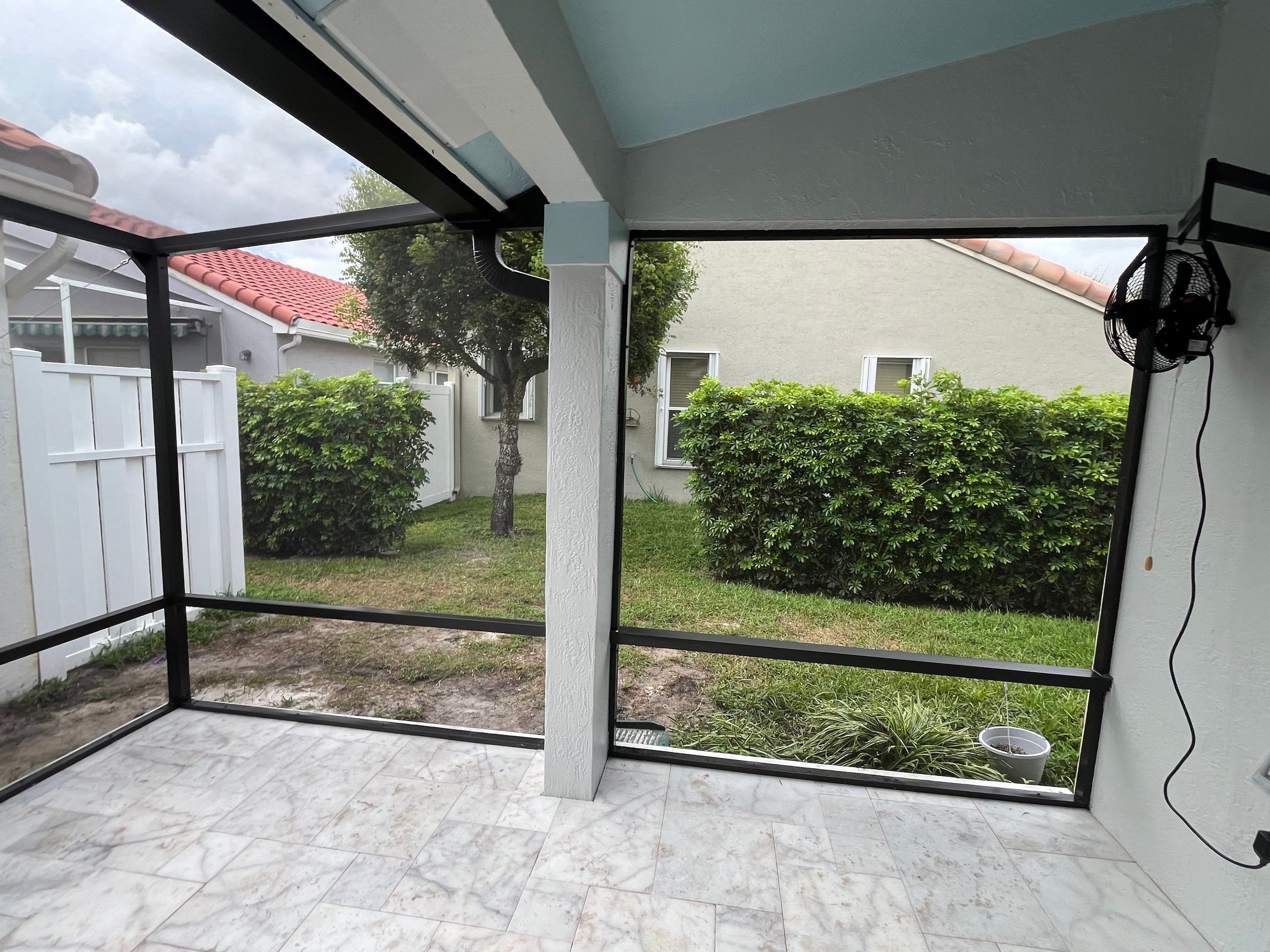 Bronze Aluminum Screen Enclosure and Marble Tile Patio in Boynton Beach by The Screen Depot, Inc
