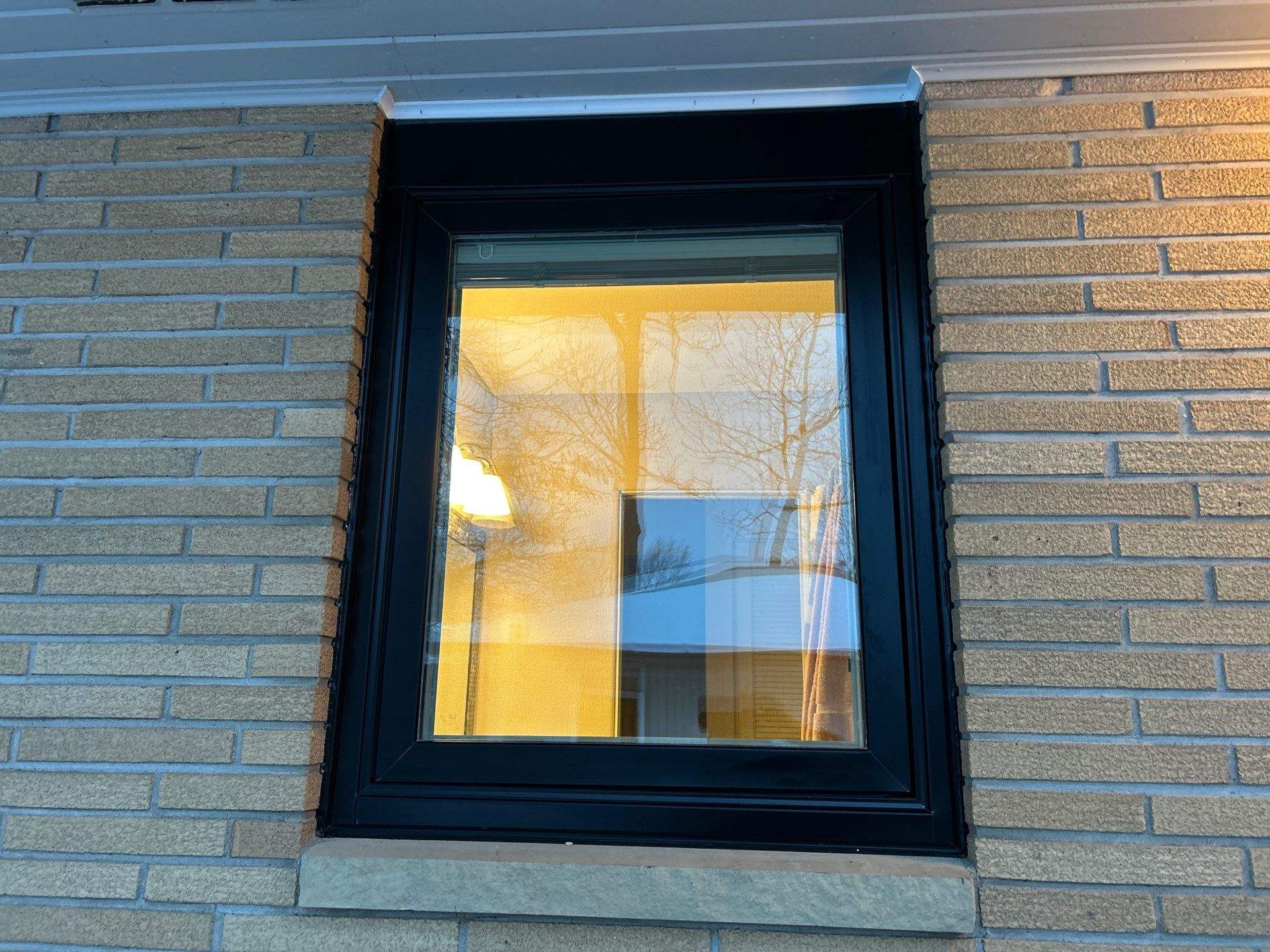 Black-Frame Pella Lifestyle Upgrade on a Partial Brick Home by United Windows and Siding LLC