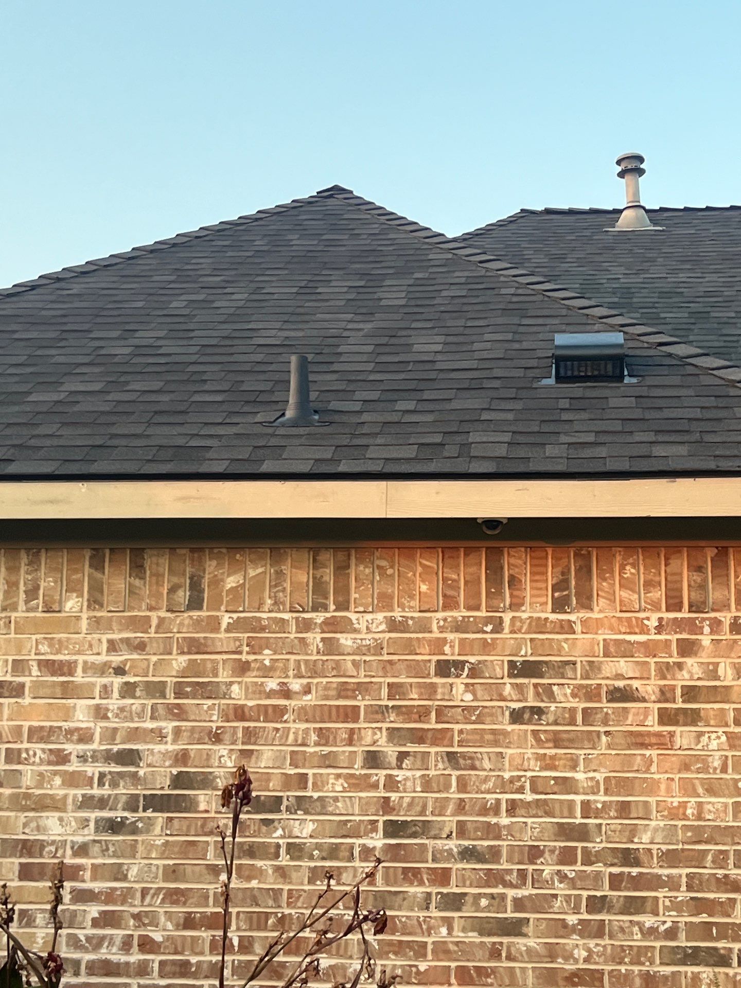 IKO Granite Black-Light Brown with dark brown sections brick house  by Tejas Roofworks + Restoration