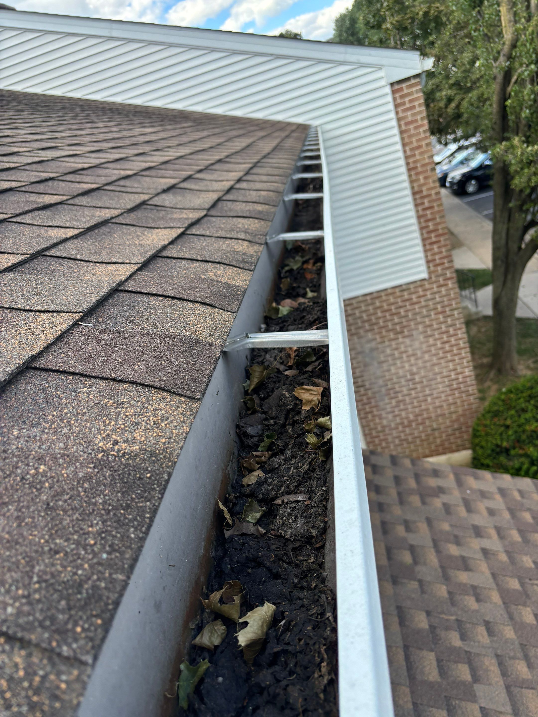 Commercial gutter cleaning Harrisburg, PA before photo with filled gutters
