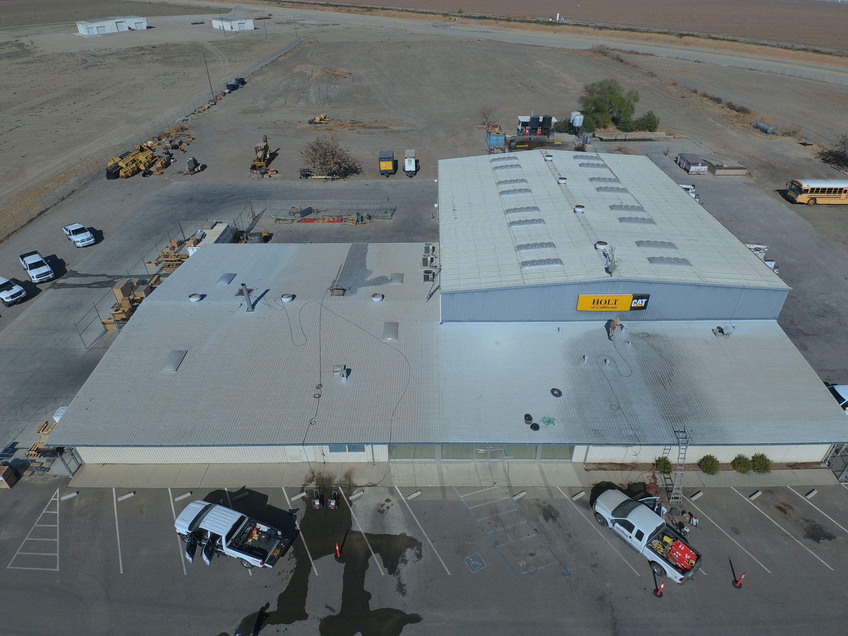 Metal roof restoration on commercial roof using Conklin Benchmark/ PUMA XL acrylic coatings over metal and foam by Straight Edge Roofing Inc