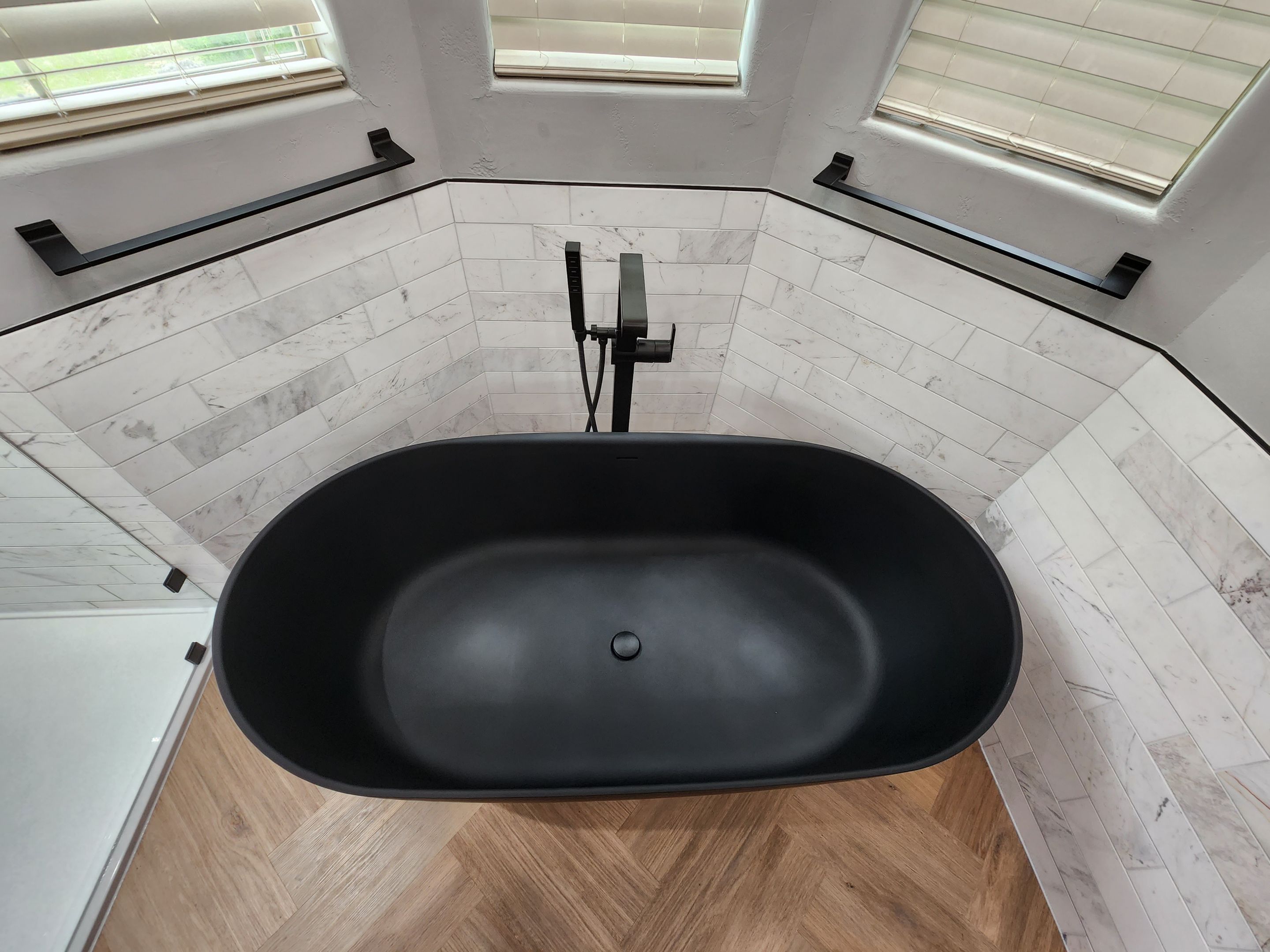 Spring Bathroom Remodel with Black Free-Standing Tub and Walk-In Shower by Legacy Bath and Kitchen