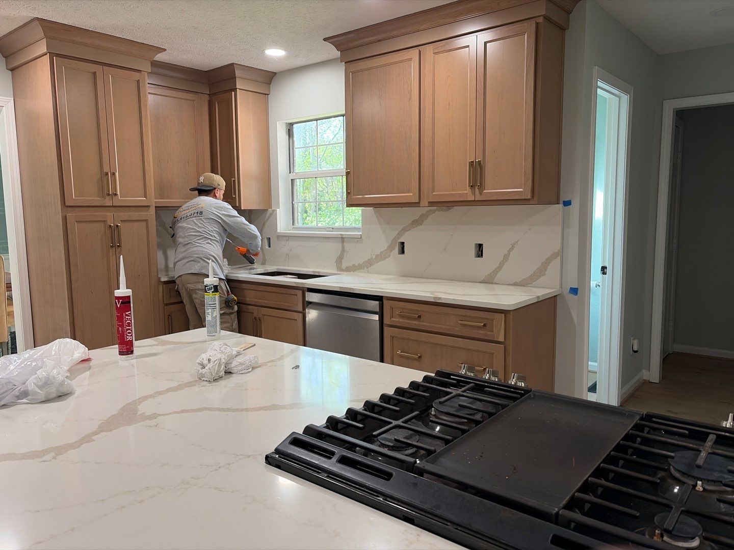Modern Kitchen Remodel Featuring Quartz Backsplash, under cabinet lighintg, and a coffee bar in Mt. Juliet Tennessee by DeRo Renovations,LLC