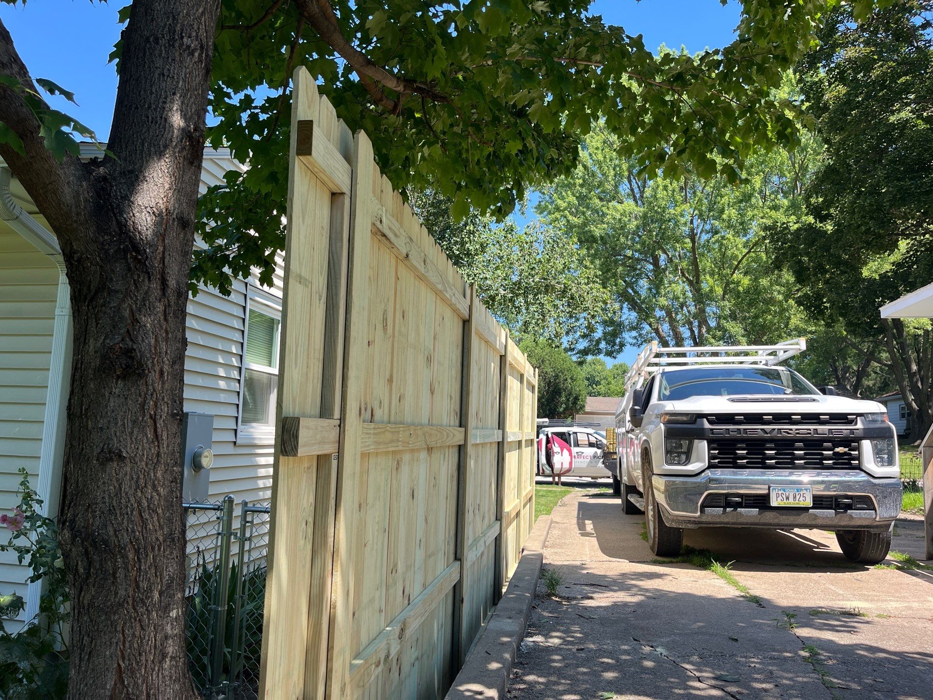 Pressure-Treated Wood Privacy Fence Installation in Cedar Falls by Perfect Picket Fence and Stain