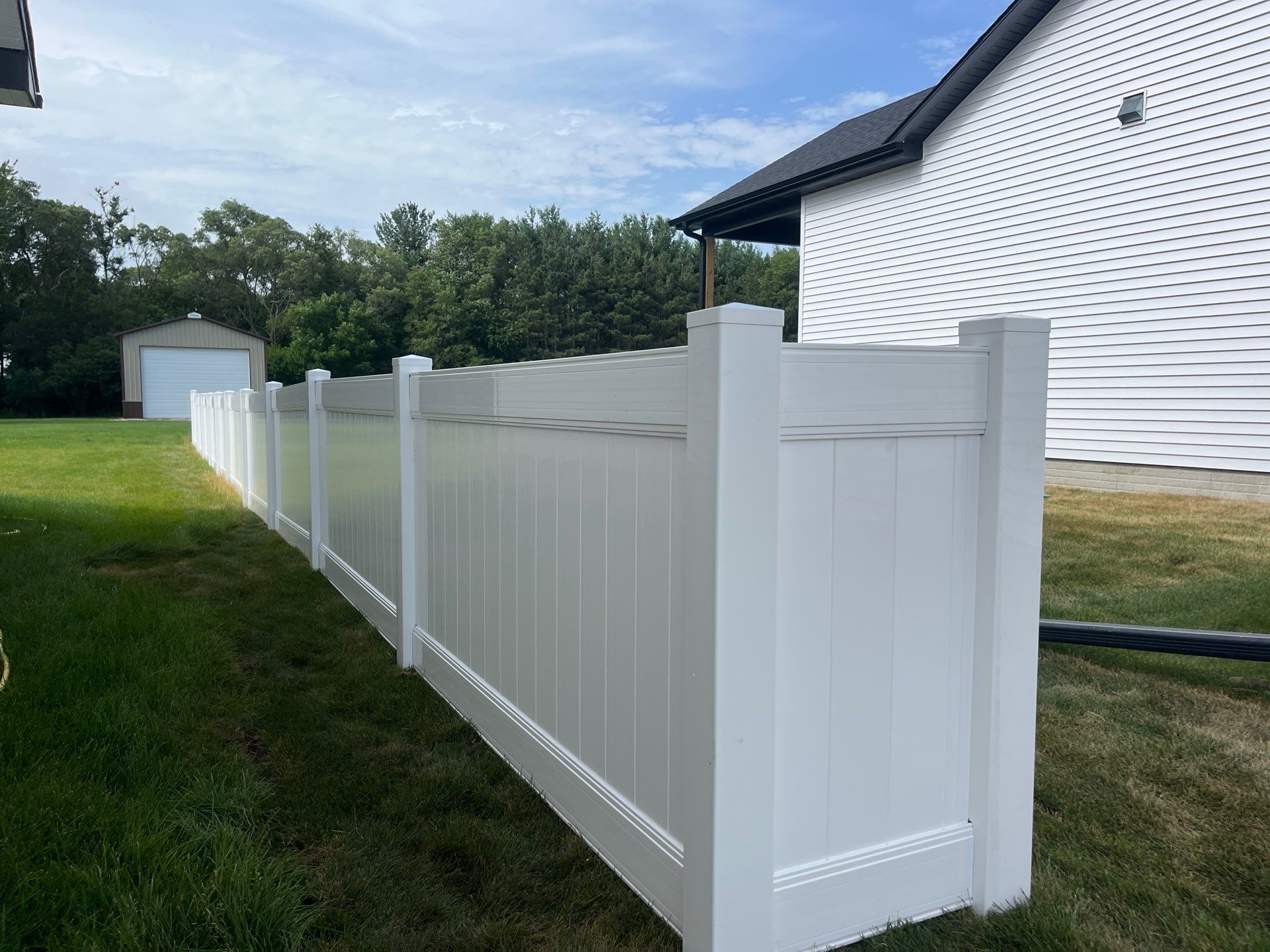 White Vinyl Privacy Fence With Pet Window in Cedar Falls by Perfect Picket Fence and Stain