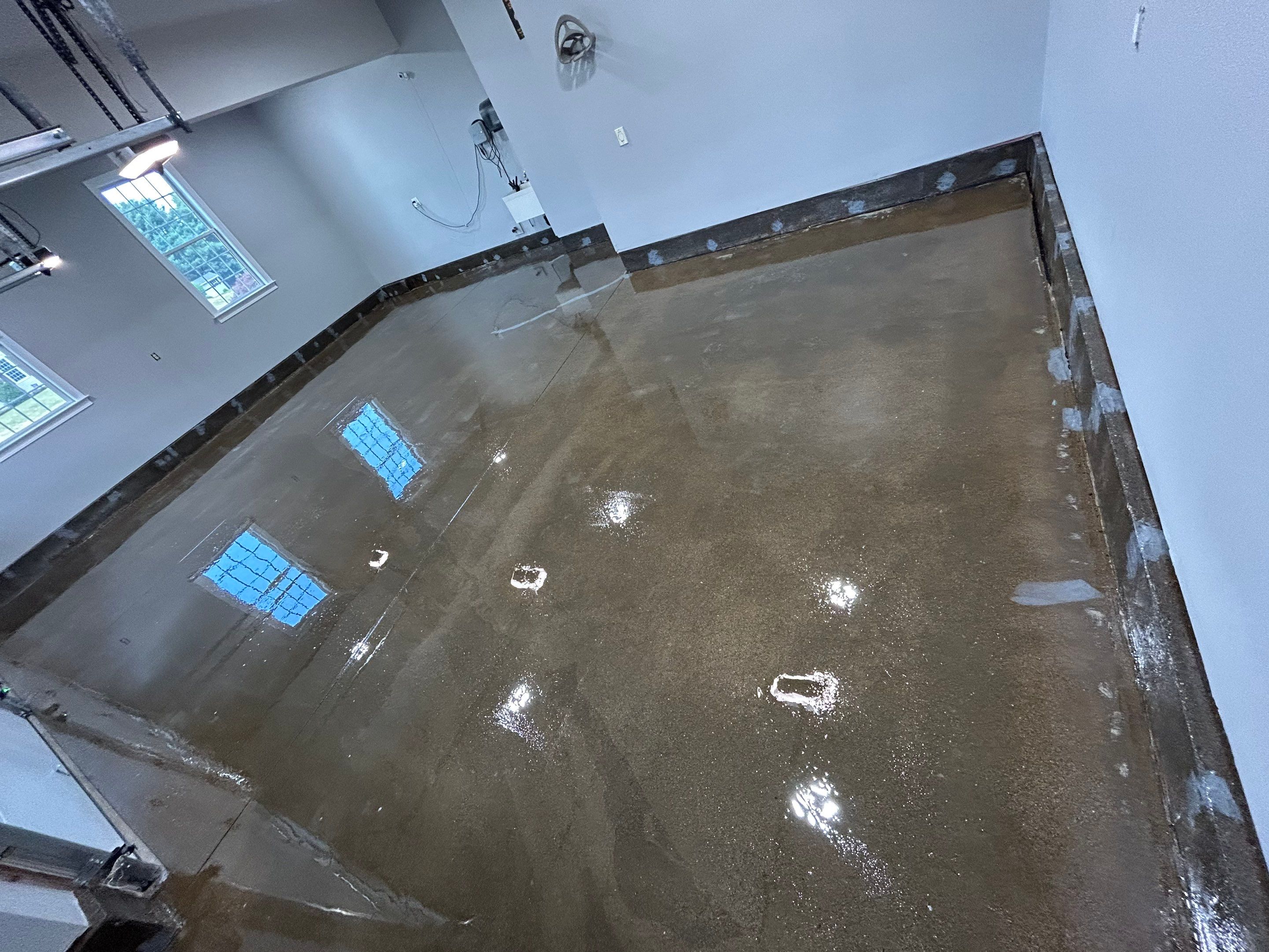 Concrete Floor Coating Transformation by DiGiorgi Roofing and Siding Inc