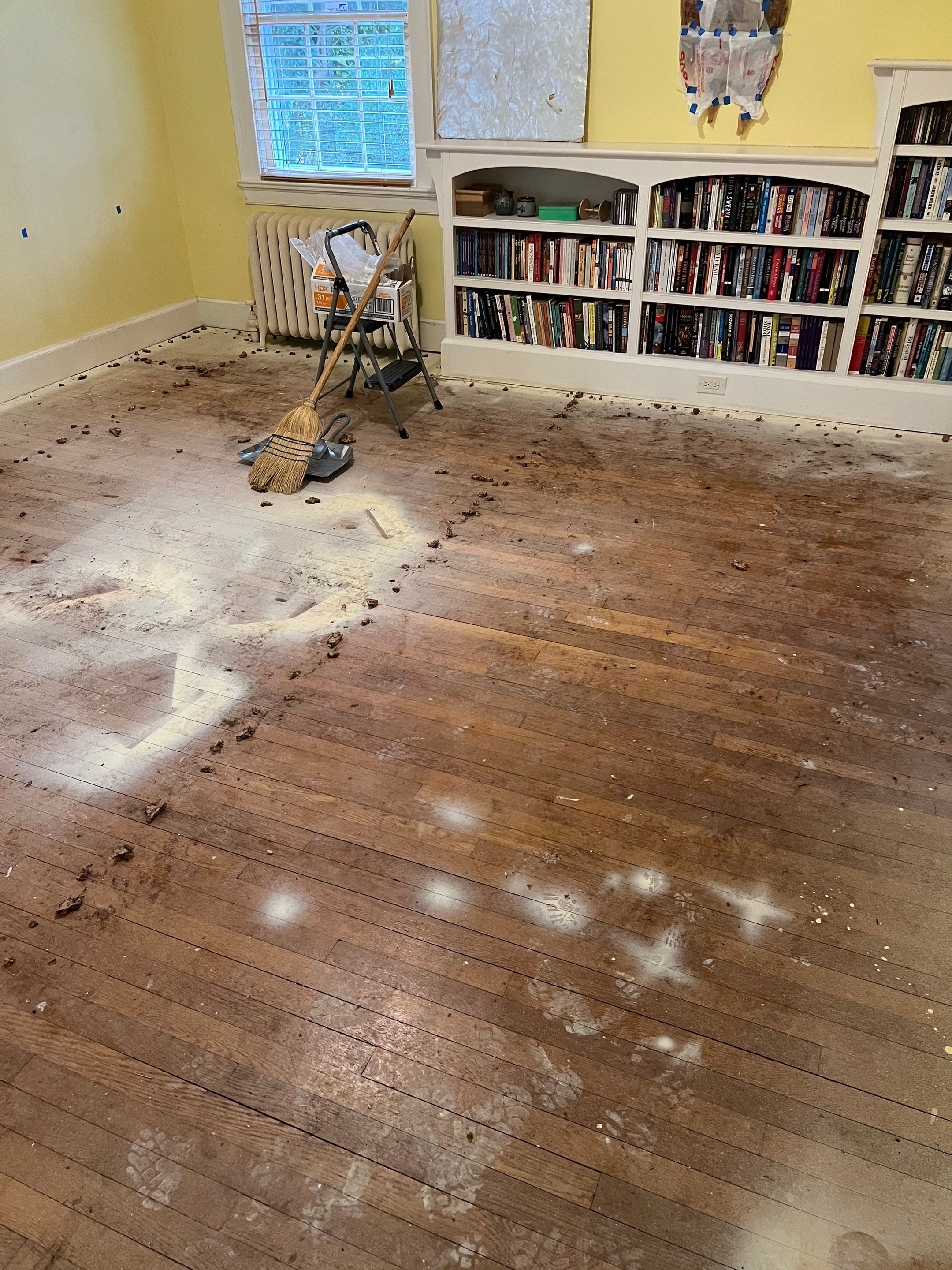 Two bedrooms with hardwood under carpet by Accent Custom Floors