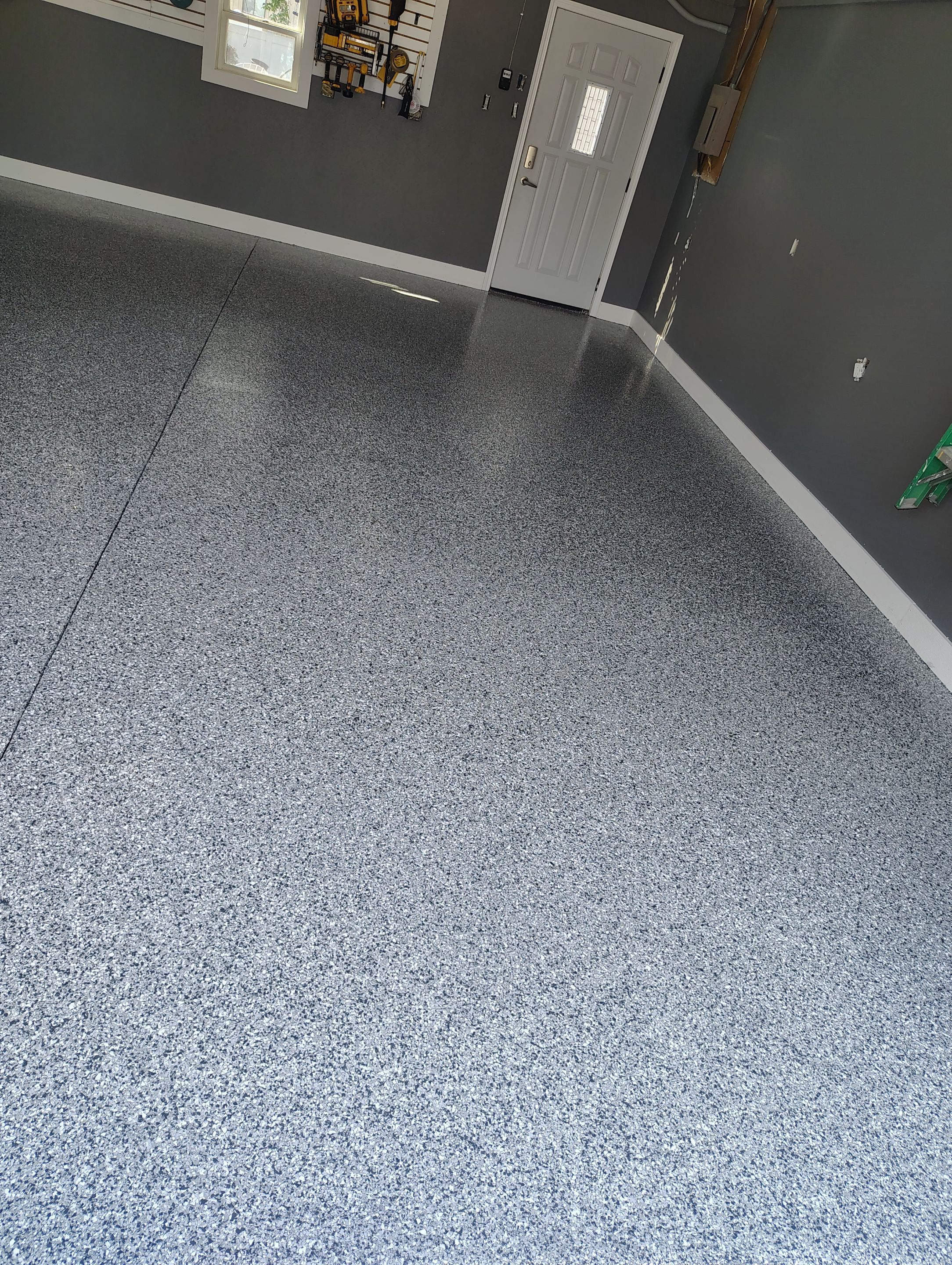 Custom Garage Floor Coating and Backyard Patio Refinishing in Tyndall by Select Painting, Coatings & Garage Cabinets