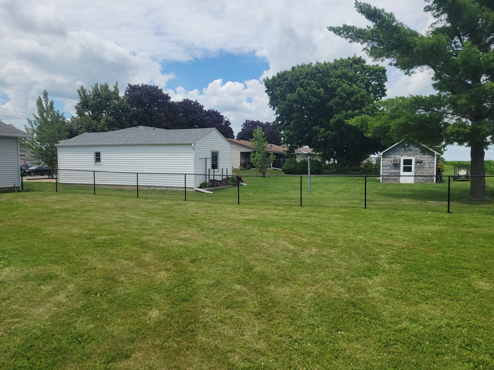Residential Black Vinyl-Coated Chain Link Fence Installation in Allison by Perfect Picket Fence and Stain