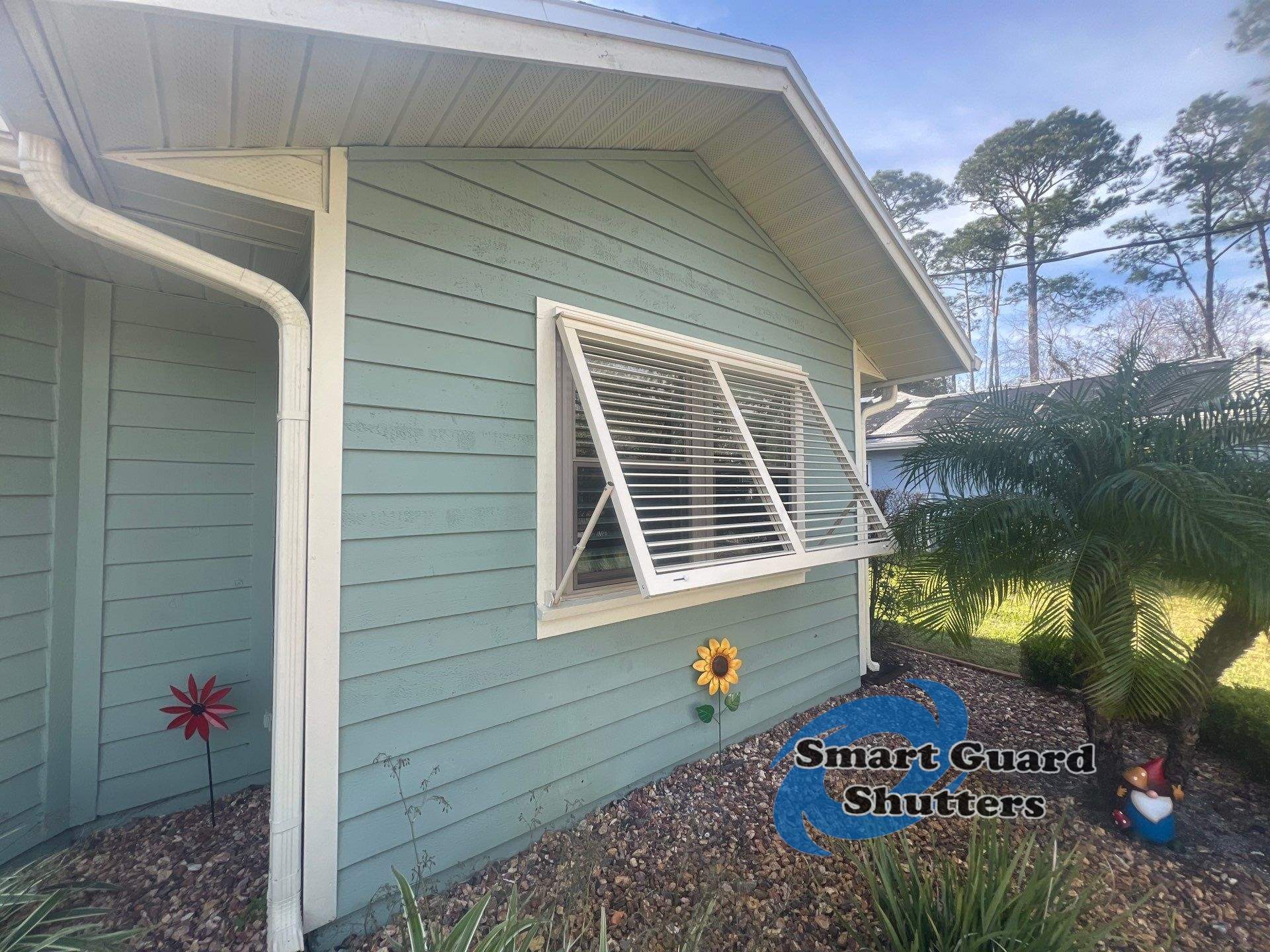 Impact Bahama Shutters in Light Ivory by Smart Guard Shutters