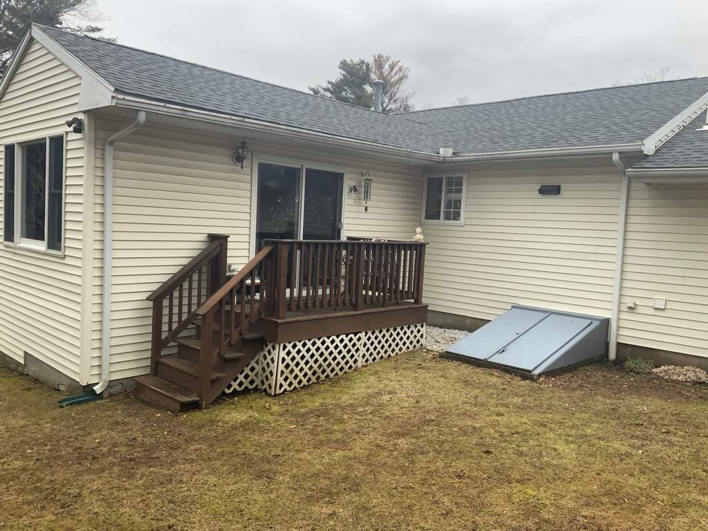 Replacement back deck using Trex Pebble Gray boards, White Composite railings and lattice. by DiGiorgi Roofing and Siding Inc