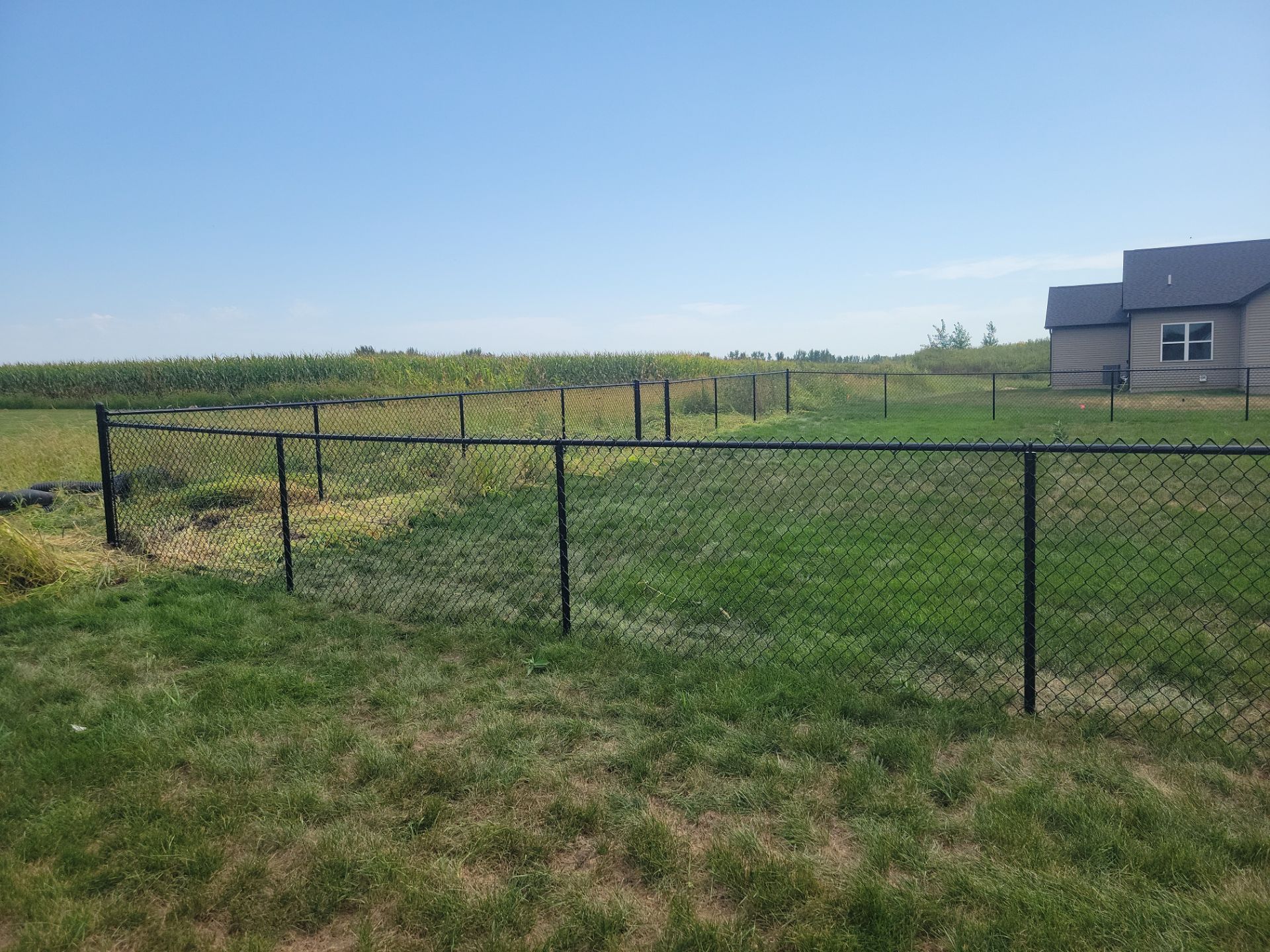 Residential Black Chain Link Fence Installation in Jesup by Perfect Picket Fence and Stain