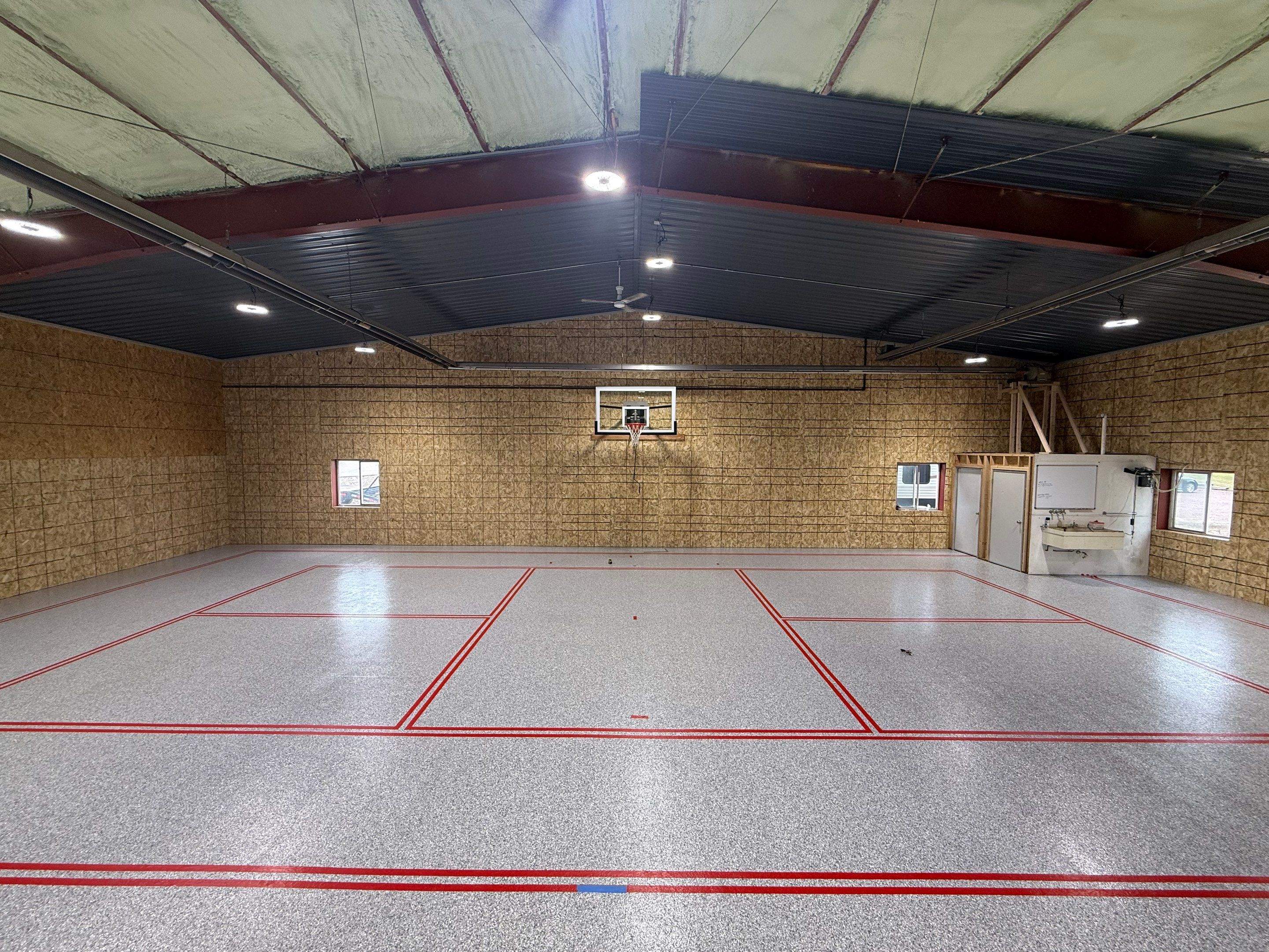 Custom Polyurea Shop Floor with Basketball Court Lines in Rock Valley by Select Painting, Coatings & Garage Cabinets