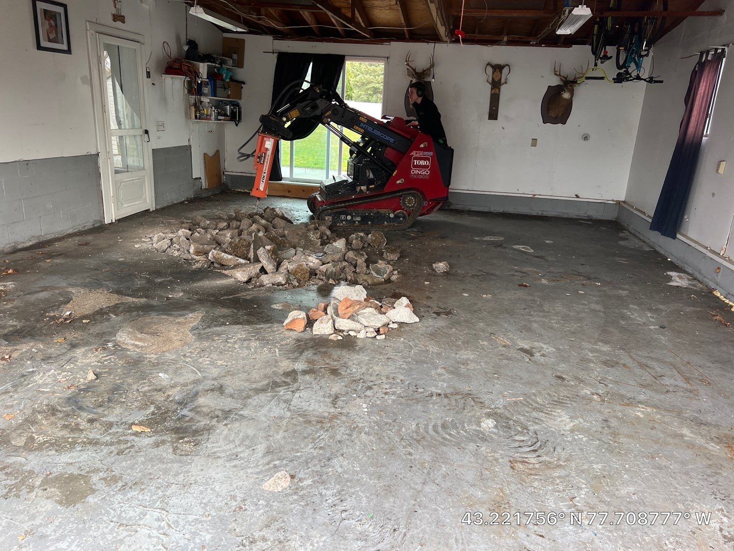 Concrete garage floor replacement with a broom finished apron and drain  by NG Masonry & Construction LLC