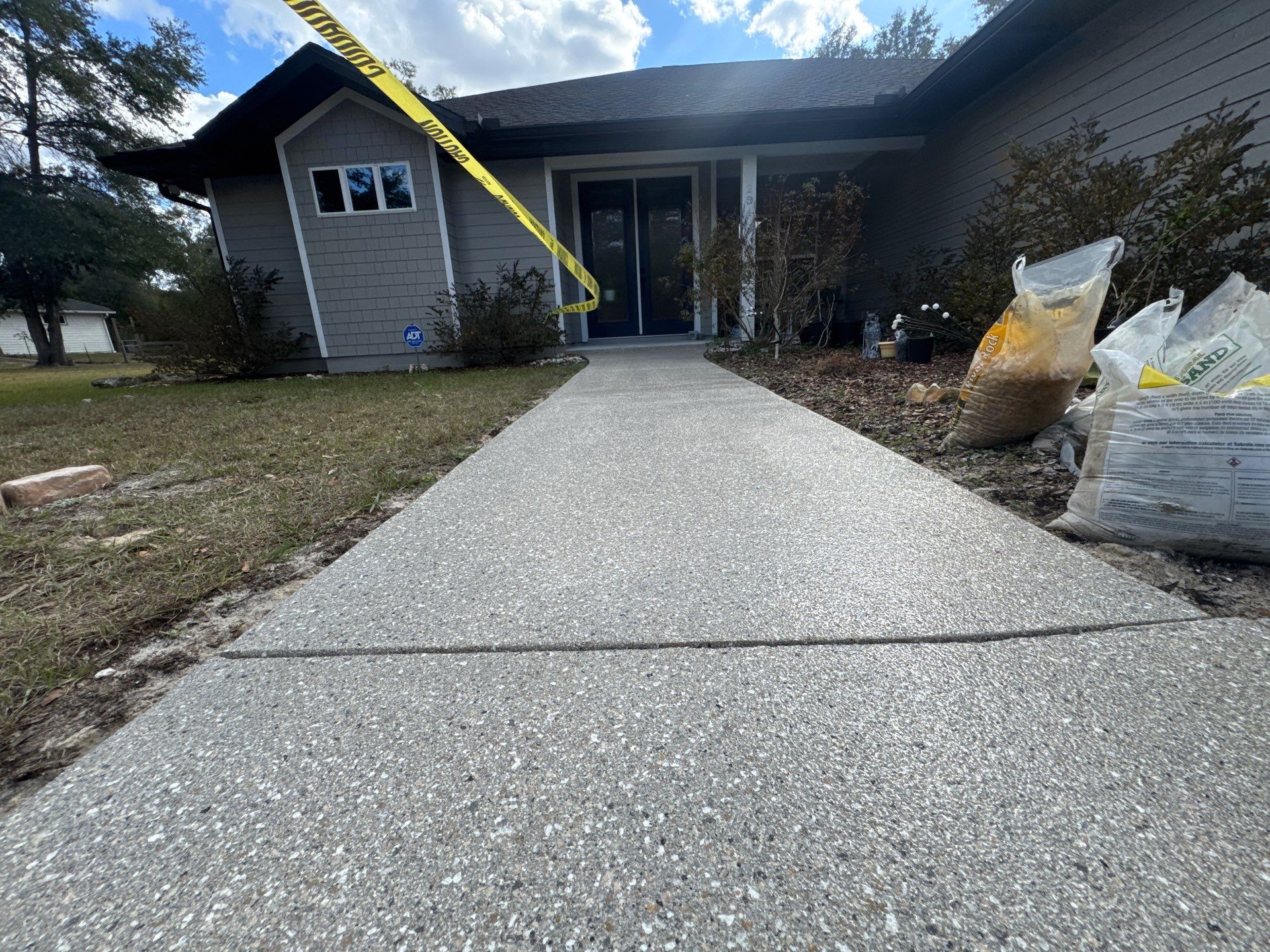 Patio and Sidewalk in Fort White, FL (Patio in Mediterranean, Sidewalk in Claystone Custom Hybrid) by Cross Creek Concrete Coatings