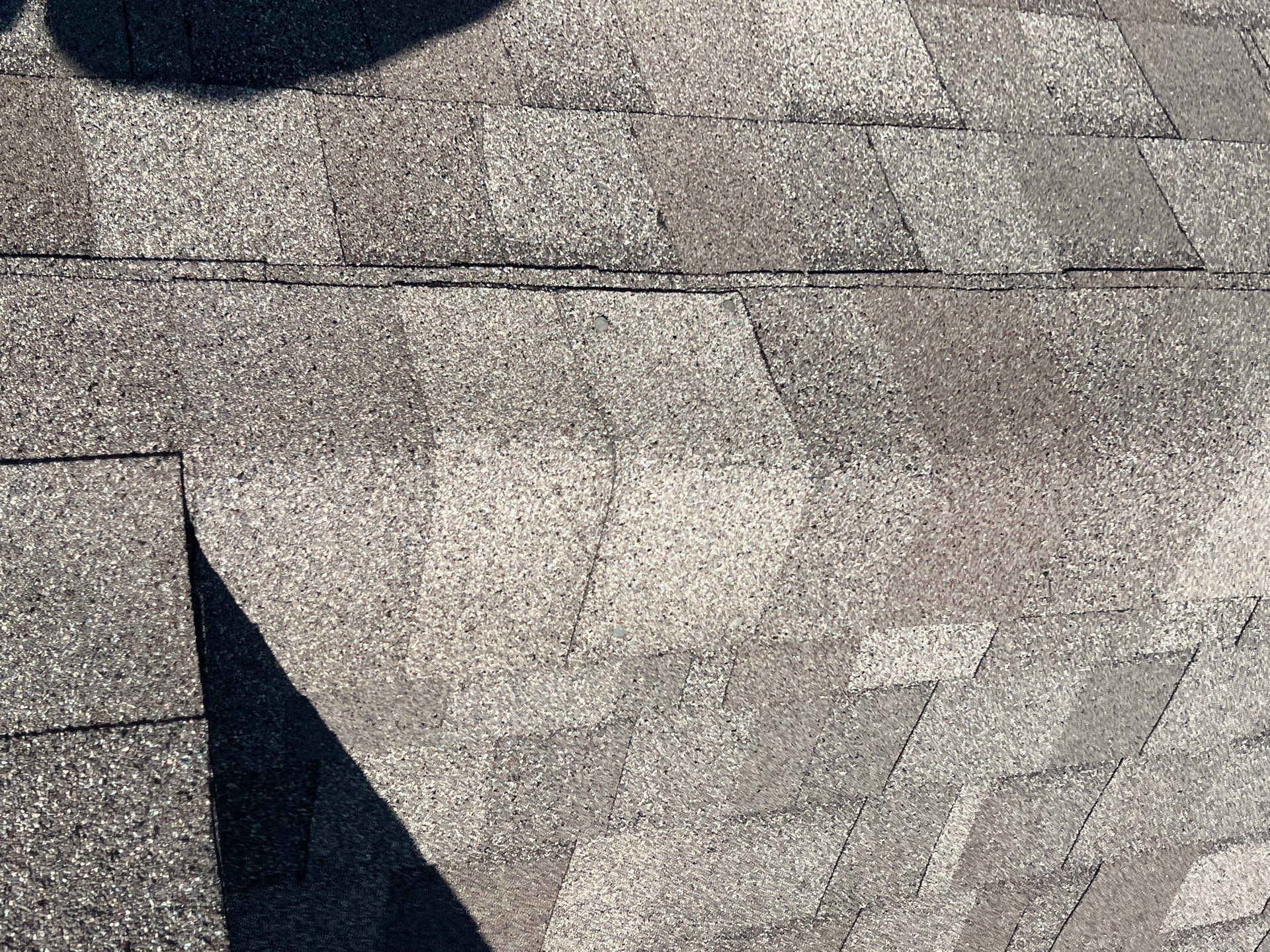 Missing shingles from wind damage on a North Texas roof