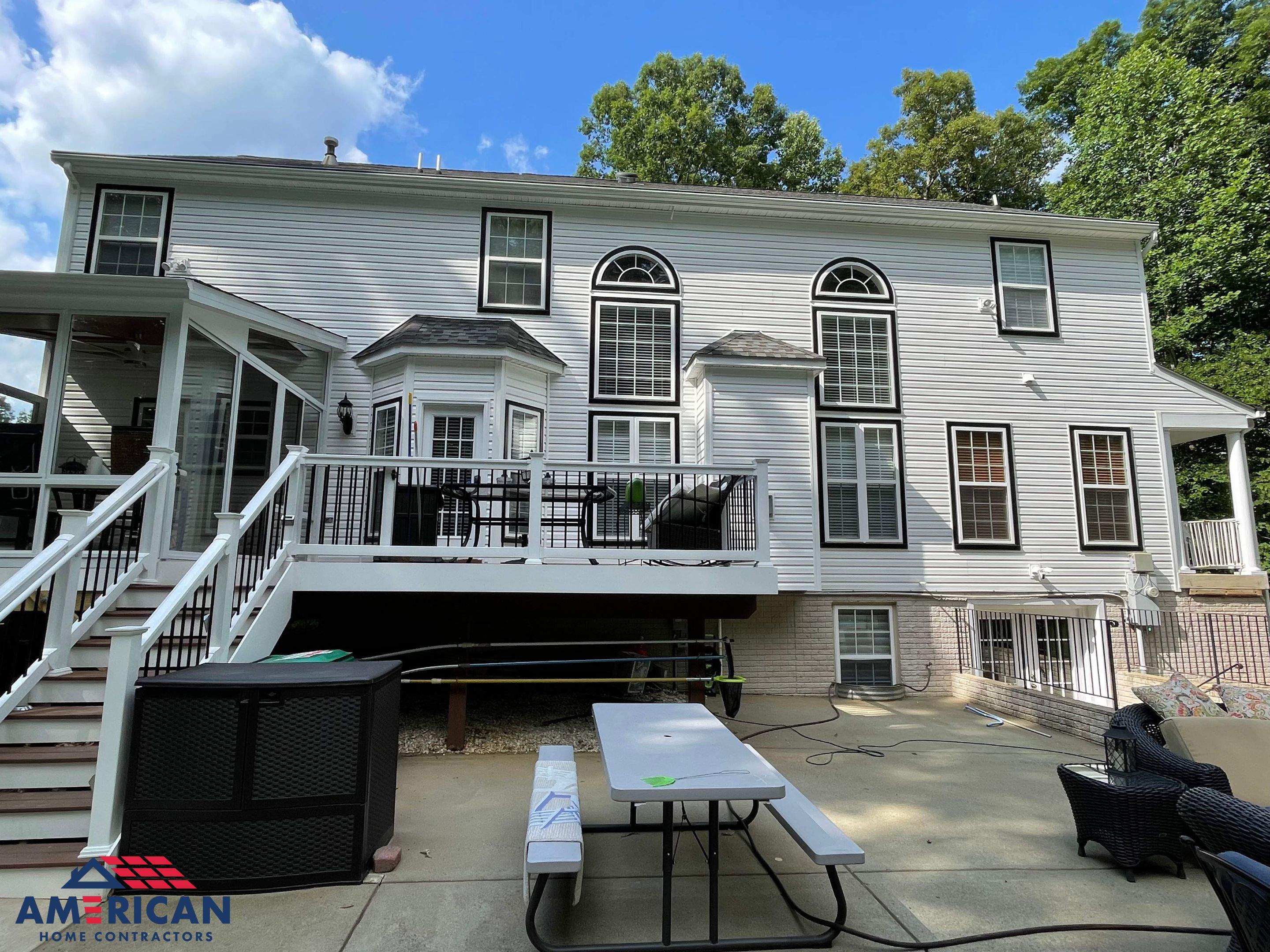 Vinyl Siding Replacement + Black Trim by American Home Contractors