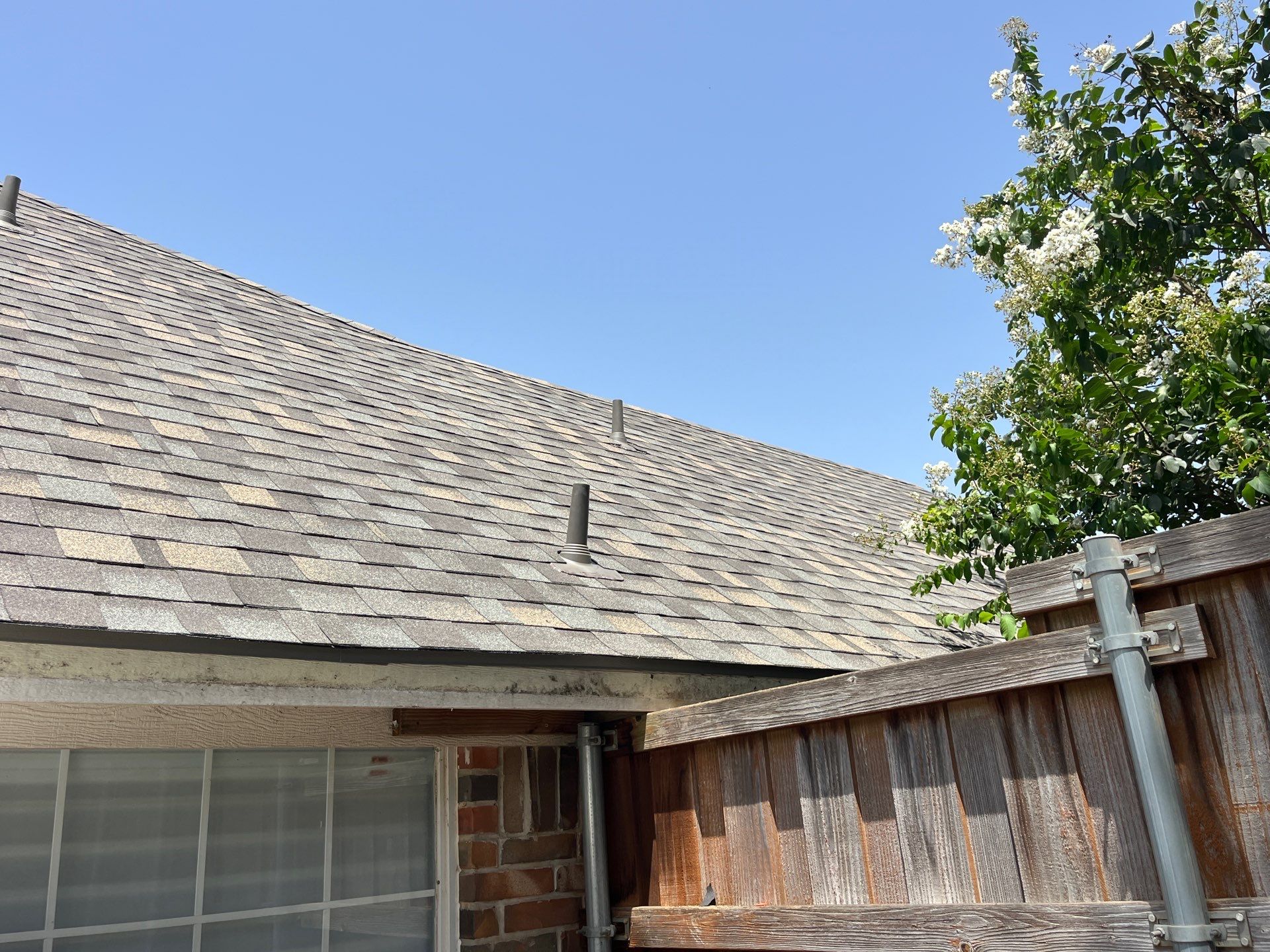 Red brick with IKO Cornerstone  by Tejas Roofworks + Restoration