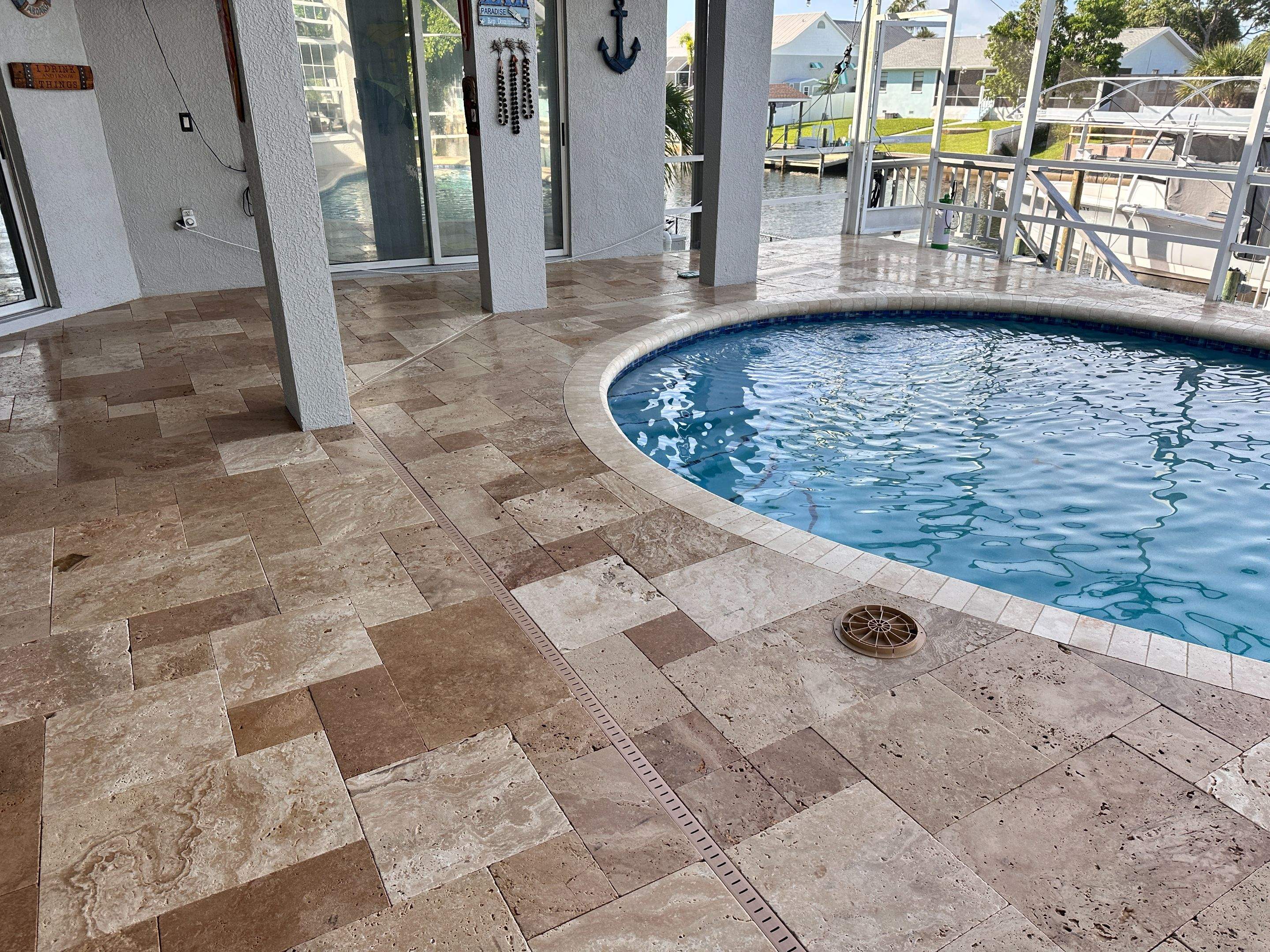 Travertine Sealing and Stripping for a Waterfront Pool Deck in Apollo Beach by Supreme Paver Experts