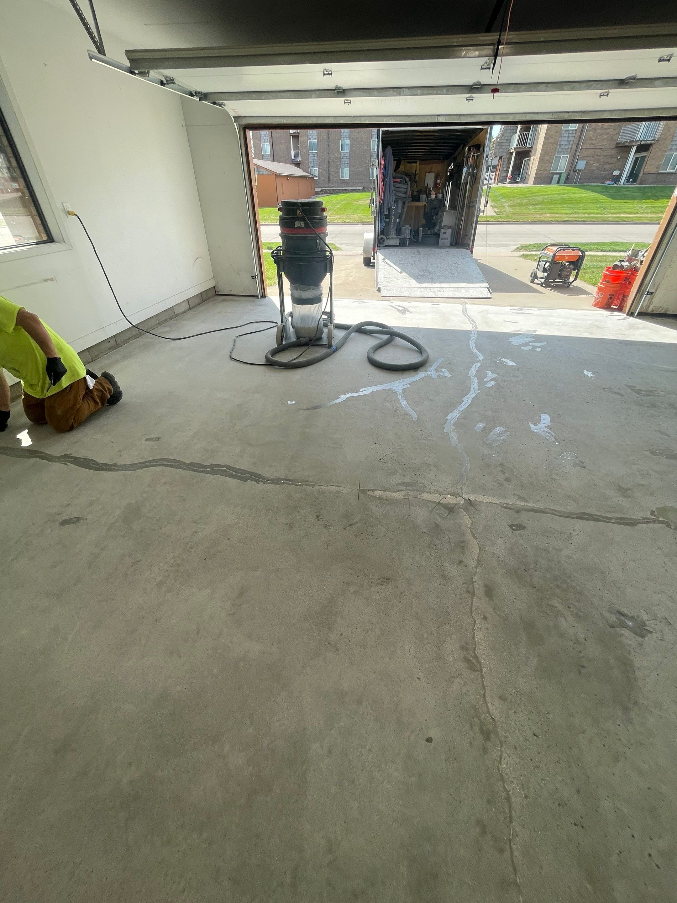 Grey Speckled Concrete Coating for Residential Garage in Yankton by Select Painting, Coatings & Garage Cabinets