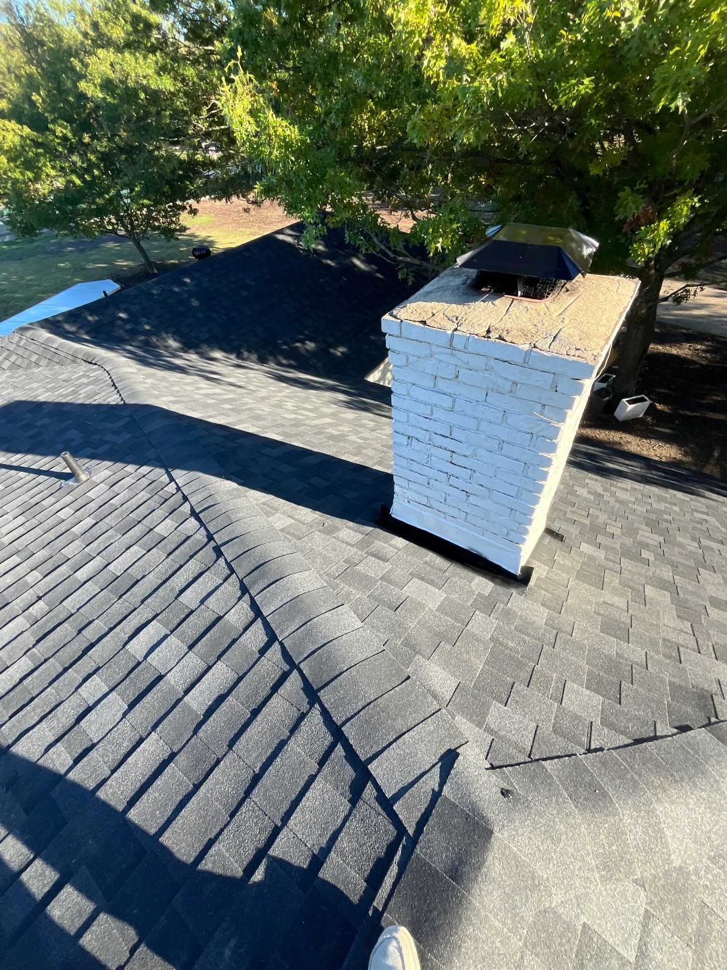 White brick with IKO Granite Black by Tejas Roofworks + Restoration