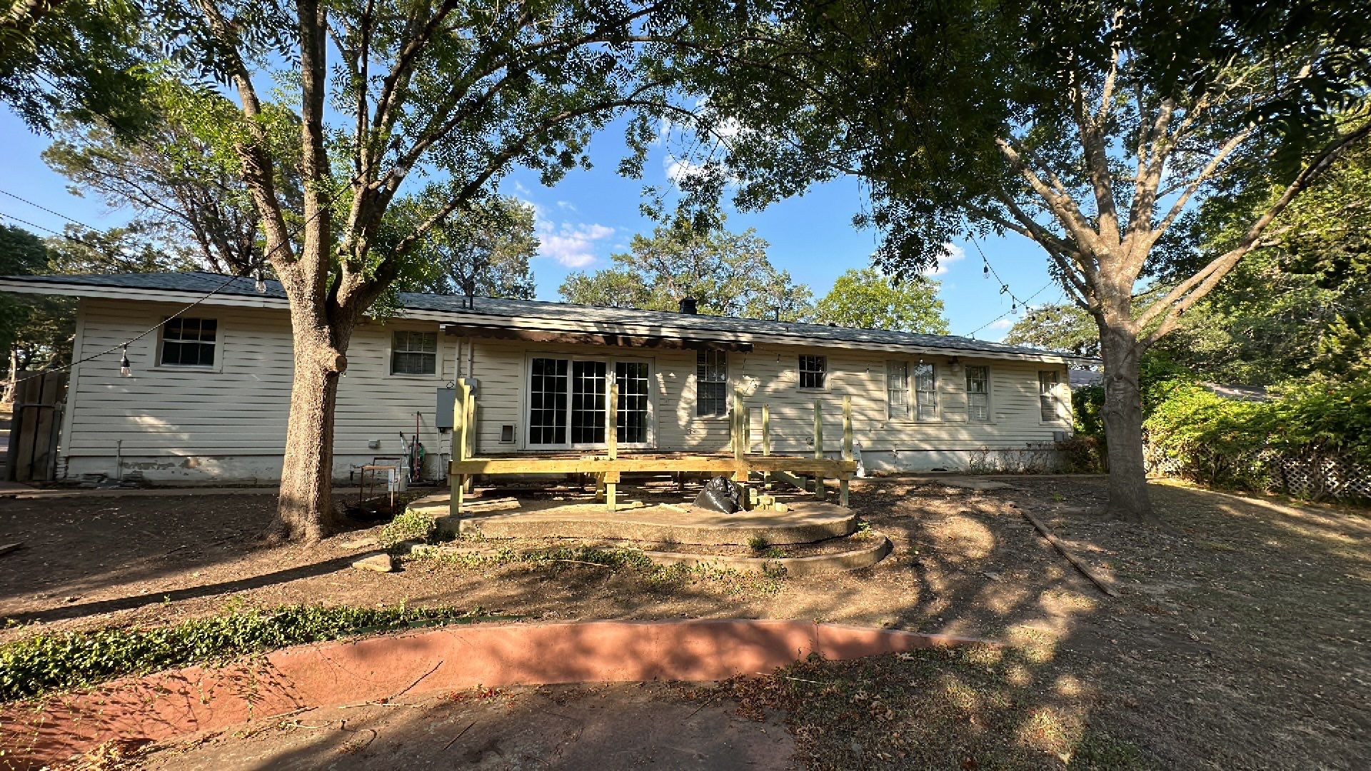White siding/white brick chimney with Malarkey Silverwood by Tejas Roofworks + Restoration