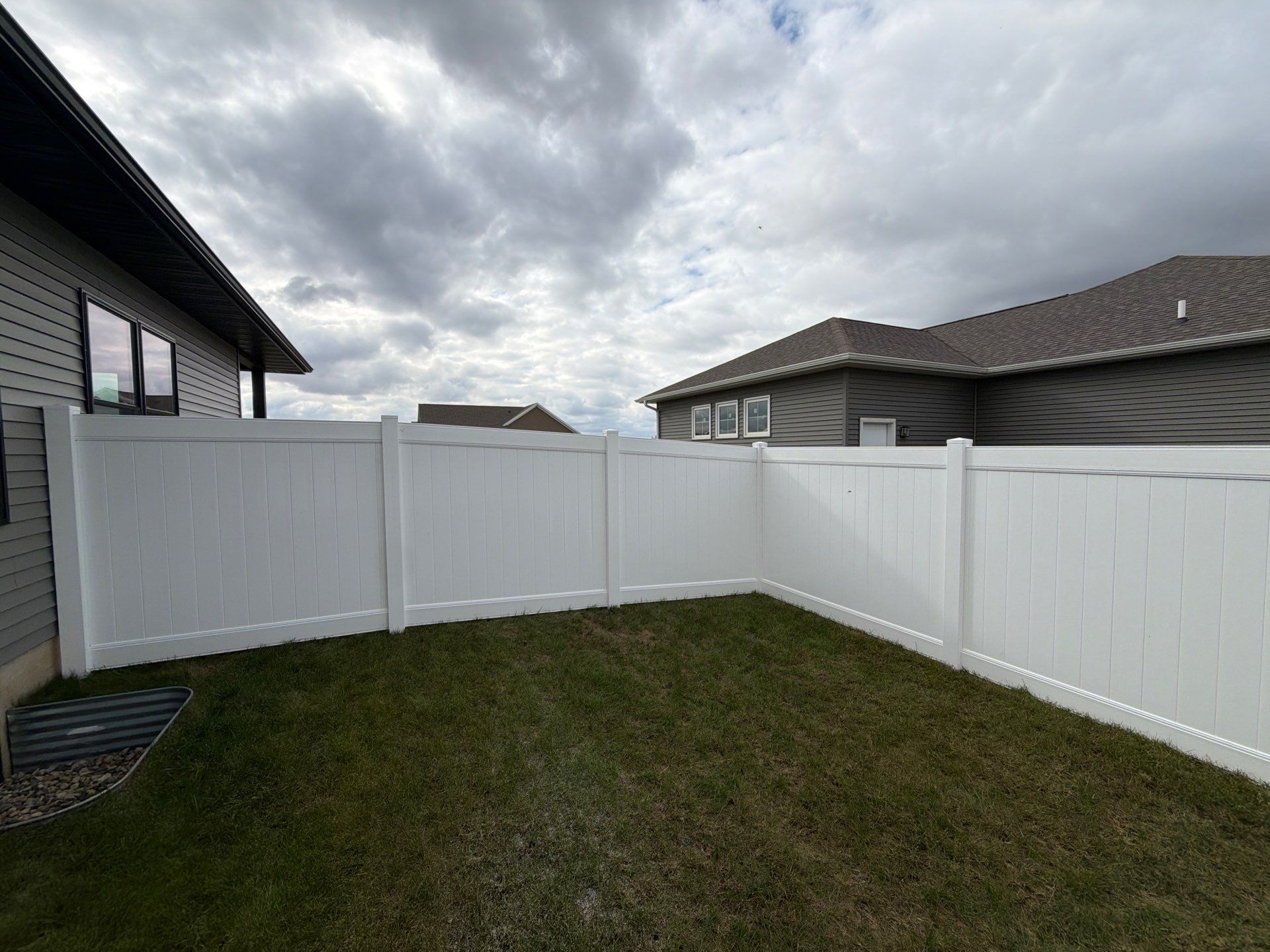 Residential White Vinyl Privacy Fence Installation in Janesville by Perfect Picket Fence and Stain