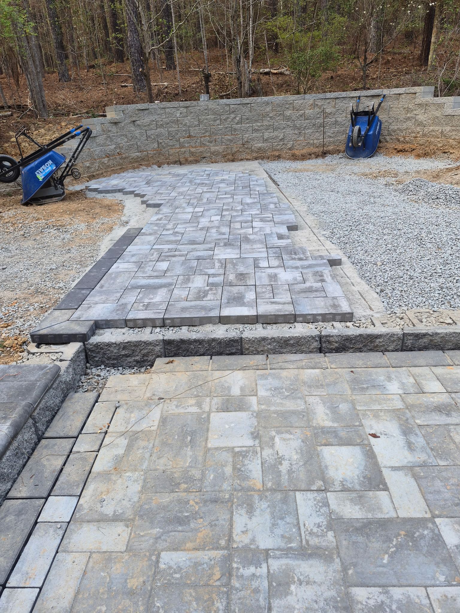 Pittsboro Outdoor Living Transformation – Retaining Wall, Paver Patio & Elevated Deck by Elite Remodeling and Design LLC