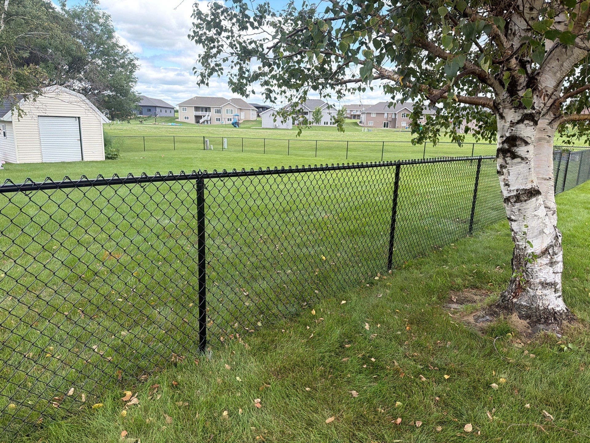 Black Vinyl-Coated Chain Link Fence Installation in Fairbank by Perfect Picket Fence and Stain