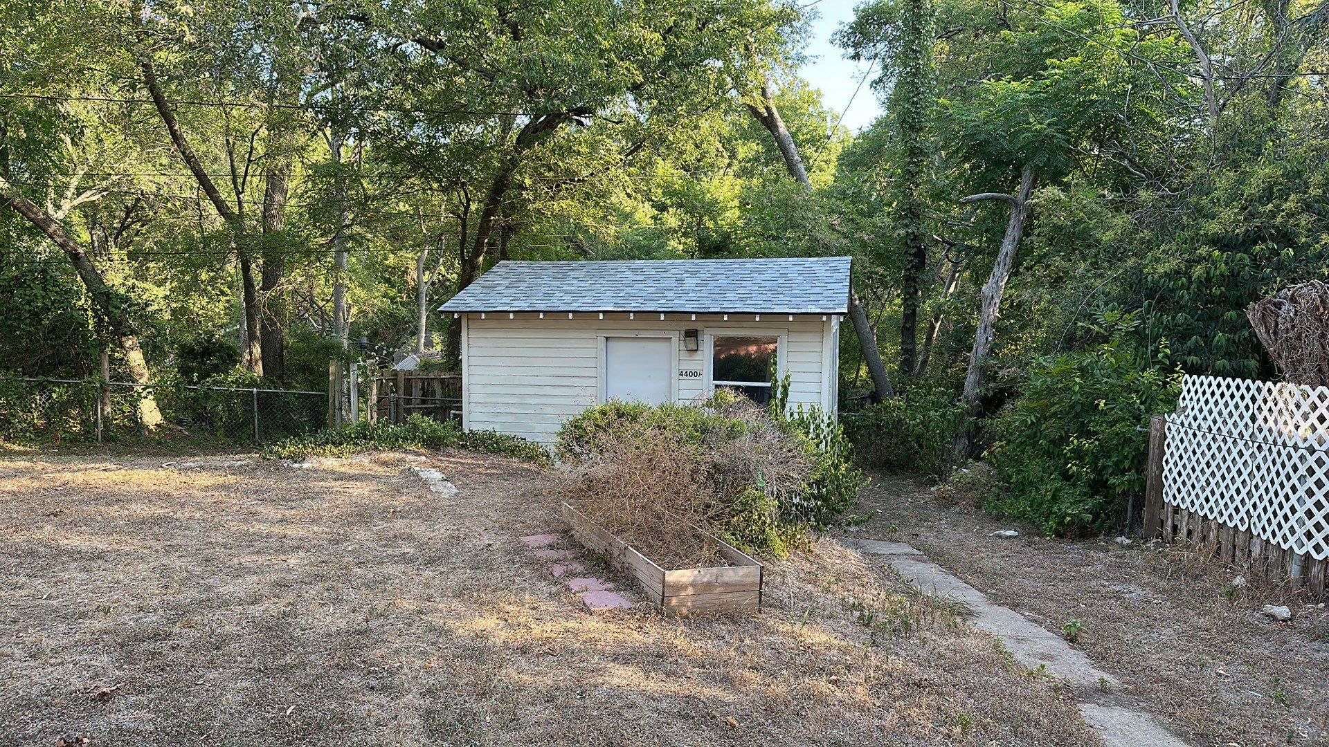 White siding/white brick chimney with Malarkey Silverwood by Tejas Roofworks + Restoration