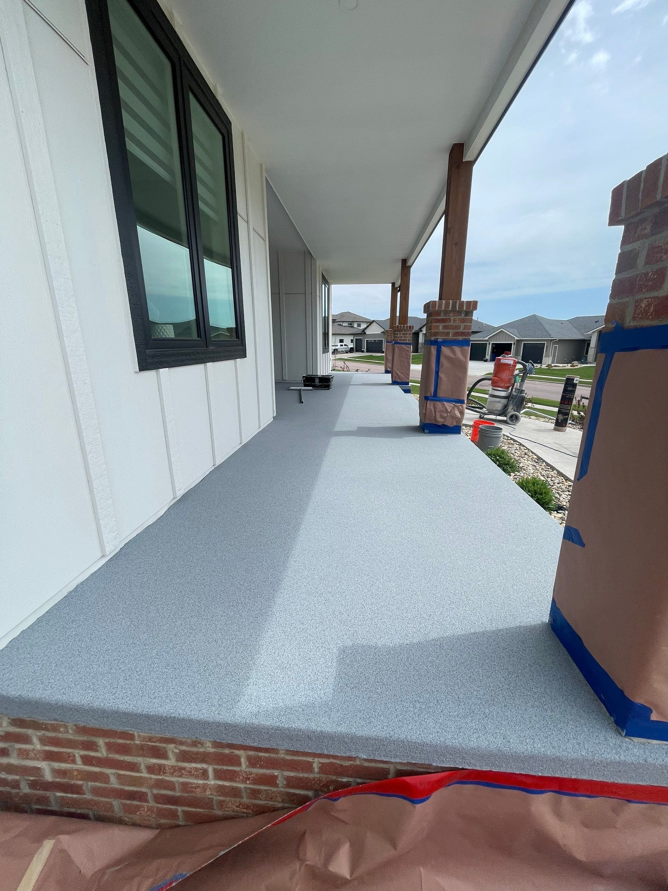Grey Speckled Concrete Porch Coating for Sioux Falls Home by Select Painting, Coatings & Garage Cabinets