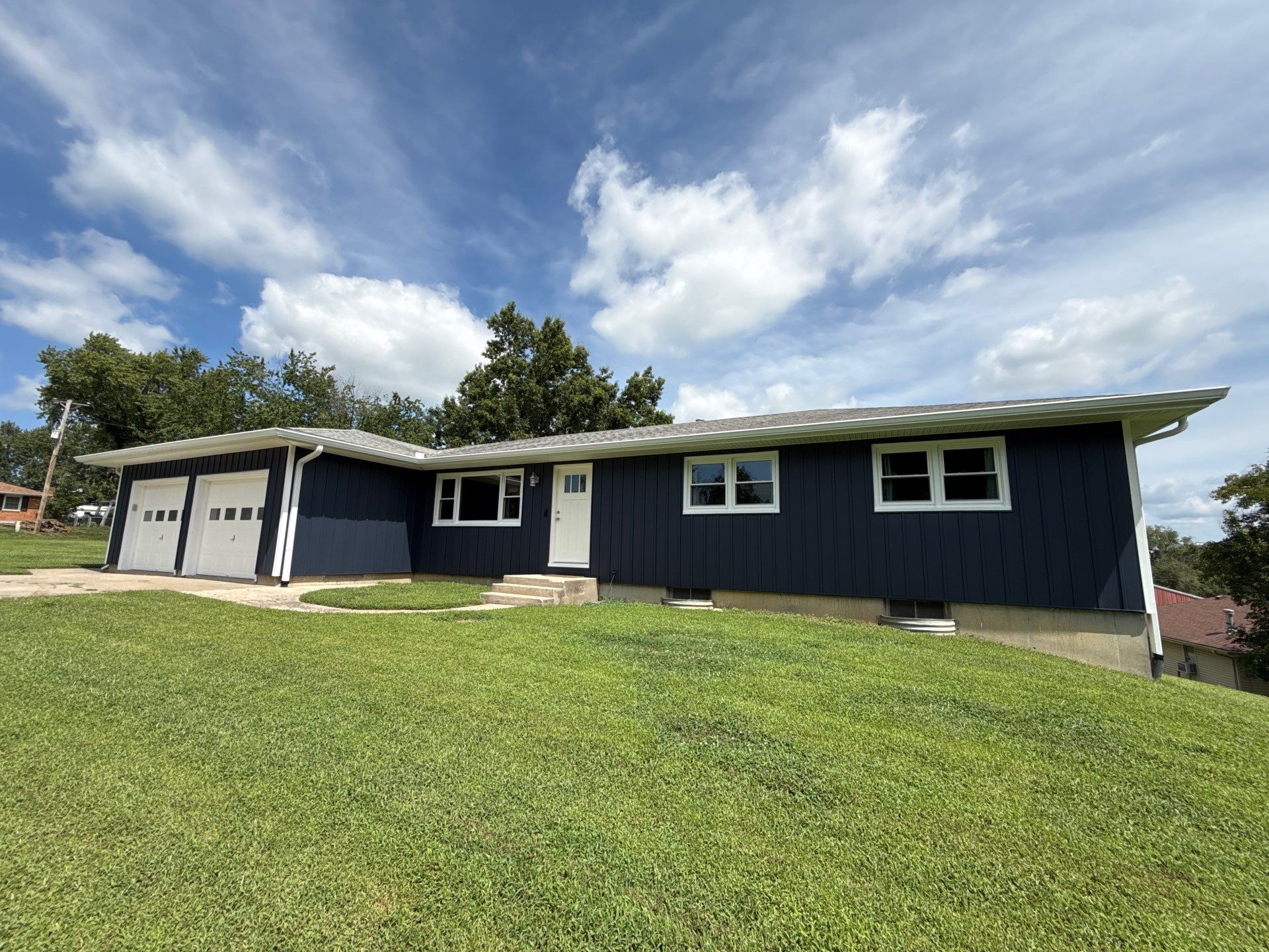 Indigo Board and Batten Siding and Window Replacement in Smithville by EEC Windows, Siding & Roofing