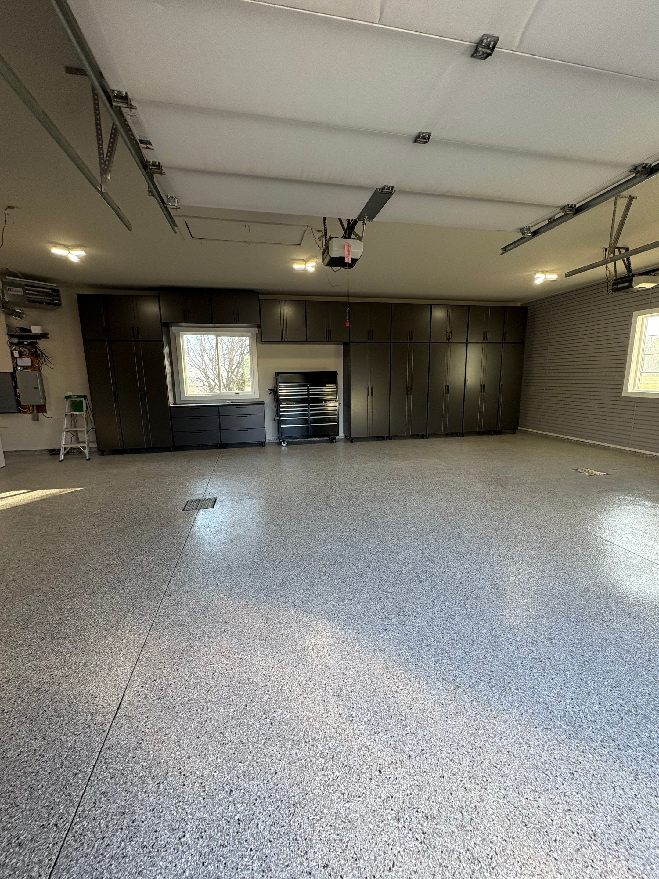 Yankton Garage Transformation with Dark Storage Cabinetry and Epoxy Flooring by Select Painting, Coatings & Garage Cabinets