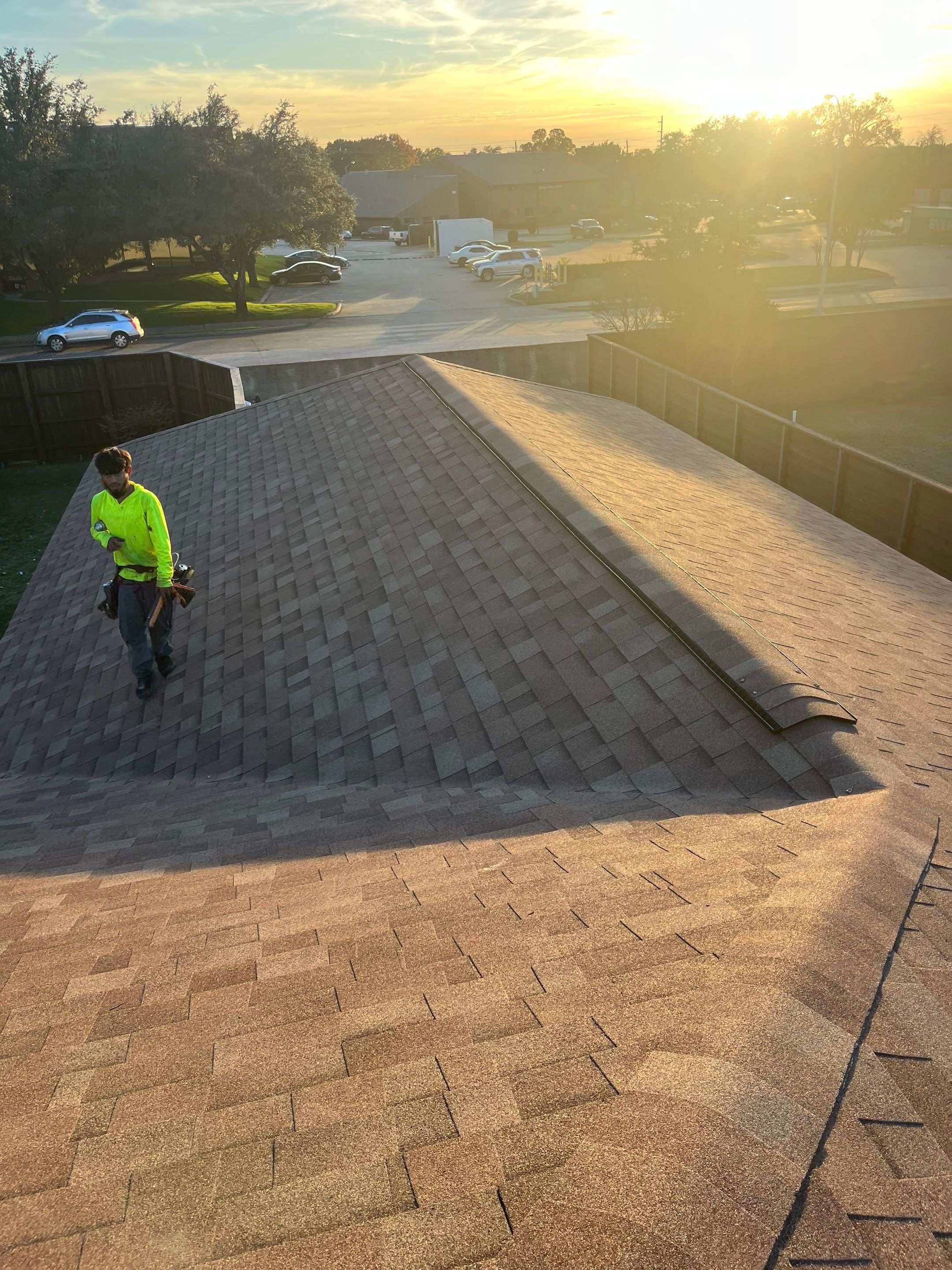 Brick with white area around windows with Malarkey Sienna Blend by Tejas Roofworks + Restoration