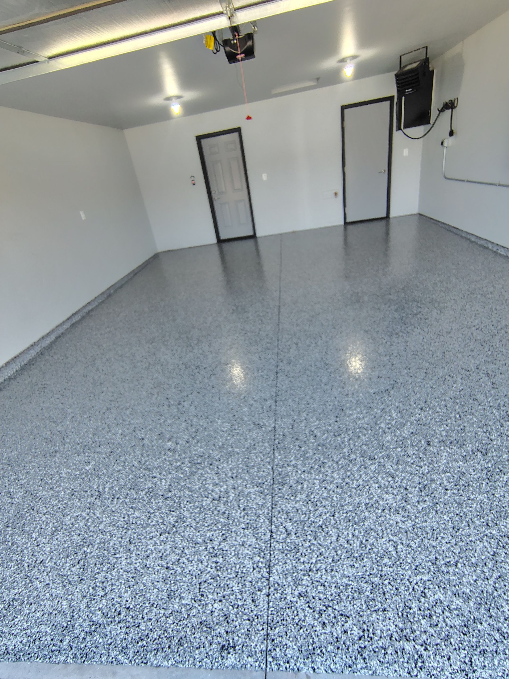 Custom Epoxy Garage Floor Coating Installation in Sioux Falls by Select Painting, Coatings & Garage Cabinets