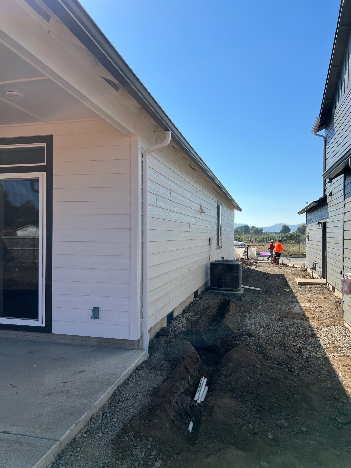 Continuous White Gutter and Downspout Installation for New Eugene Home by BEST Roofing & Waterproofing