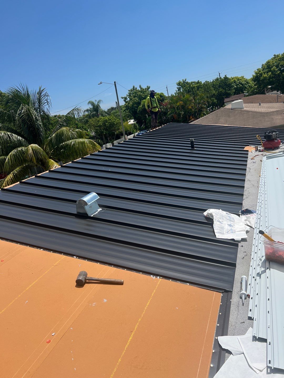 Standing Seam Metal & Flat Re-Roof using 1.5" Nail Strip 24ga Black Matte Kynar Coated Standing Seam Metal Panels by Morton Roofing, Inc.