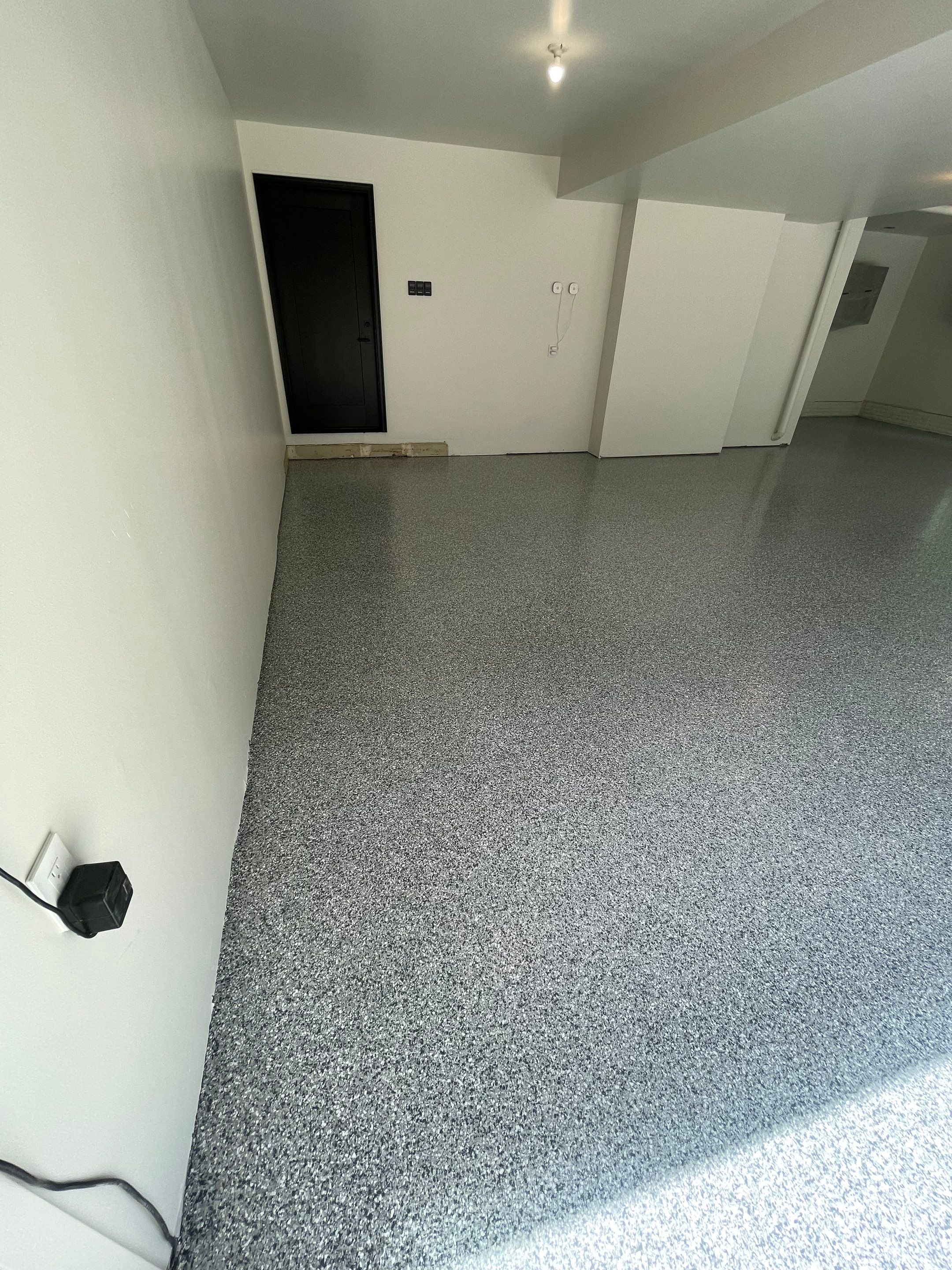 Gray Speckled Epoxy Garage Floor Coating in Sioux Falls by Select Painting, Coatings & Garage Cabinets