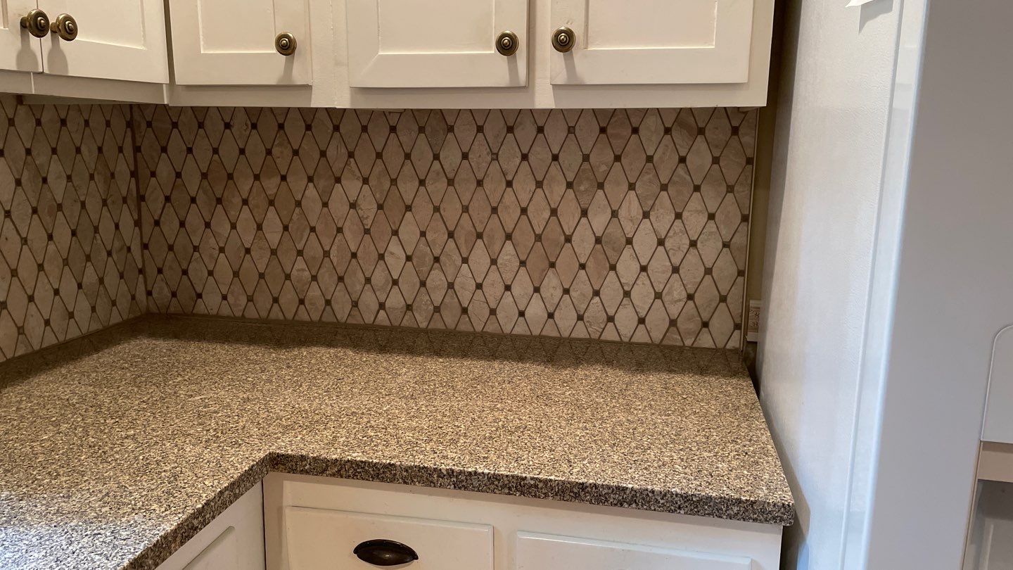 New Backsplash to Compliment the Countertops by Footprints Floors of Coastal Carolina