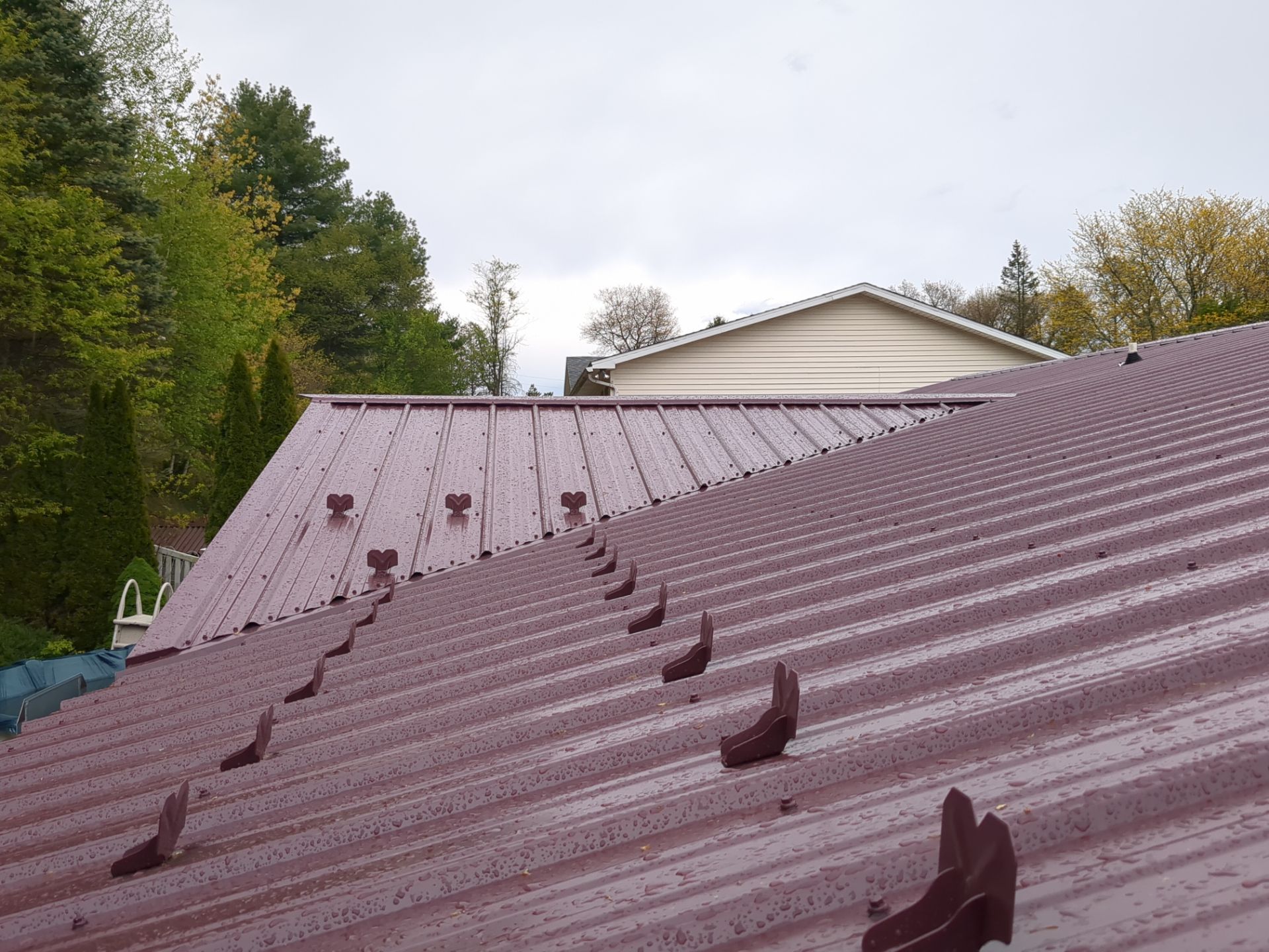 Maroon ABM Metal Roof Replacement and Gutter Installation in Shenandoah by Esh Builders