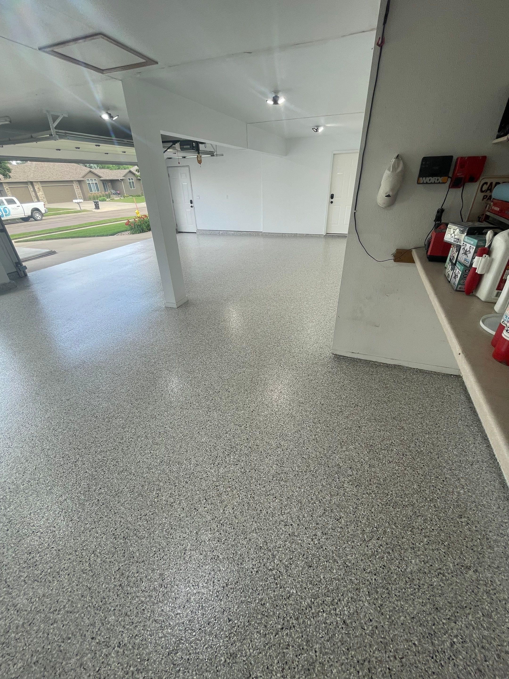 Multi-Car Garage Concrete Coating with Coyote Flake Finish in Sioux Falls by Select Painting, Coatings & Garage Cabinets