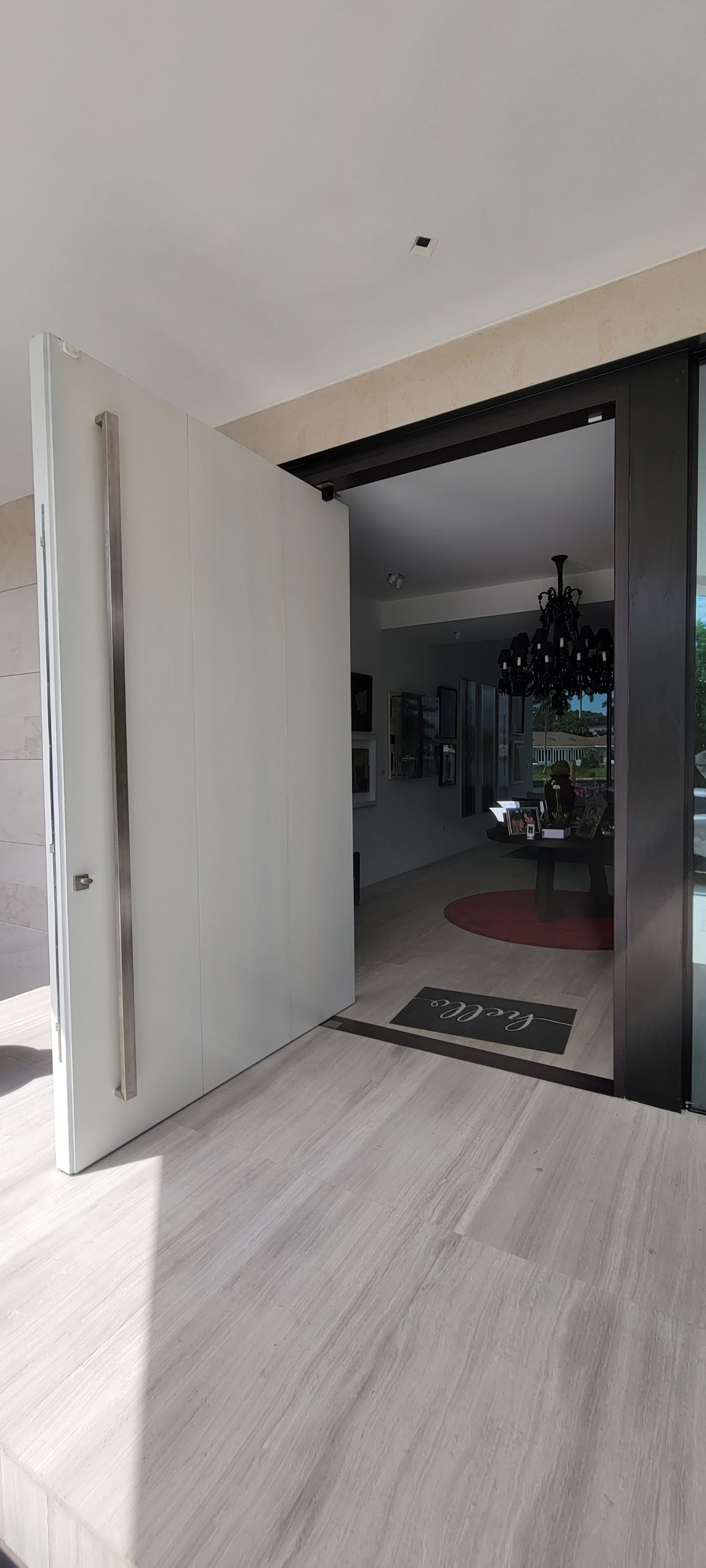 Custom Material Pivot Door installation by Impact Precious Wood Inc.