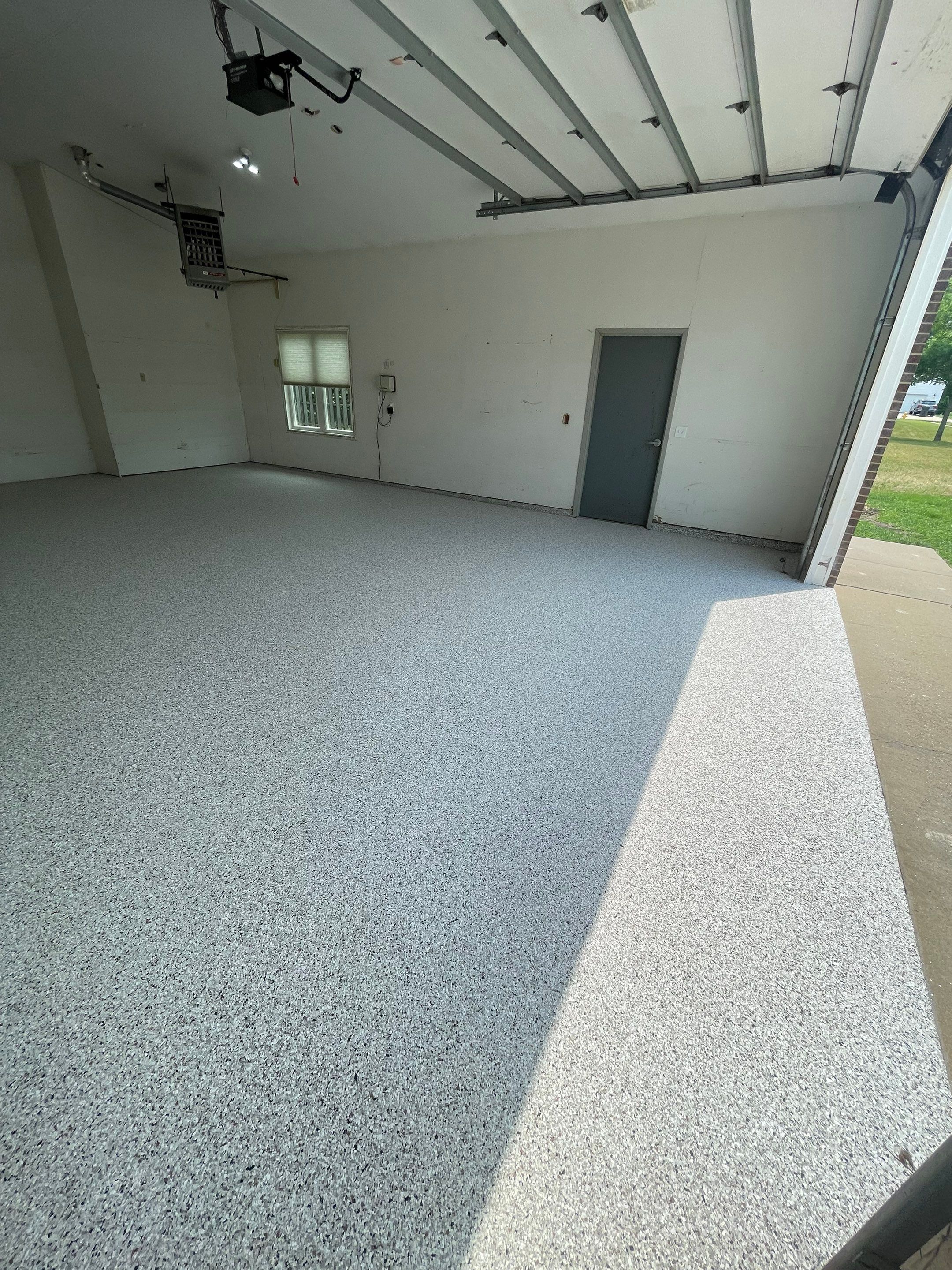 Coyote Flake Concrete Coating for Sioux Falls Garage by Select Painting, Coatings & Garage Cabinets