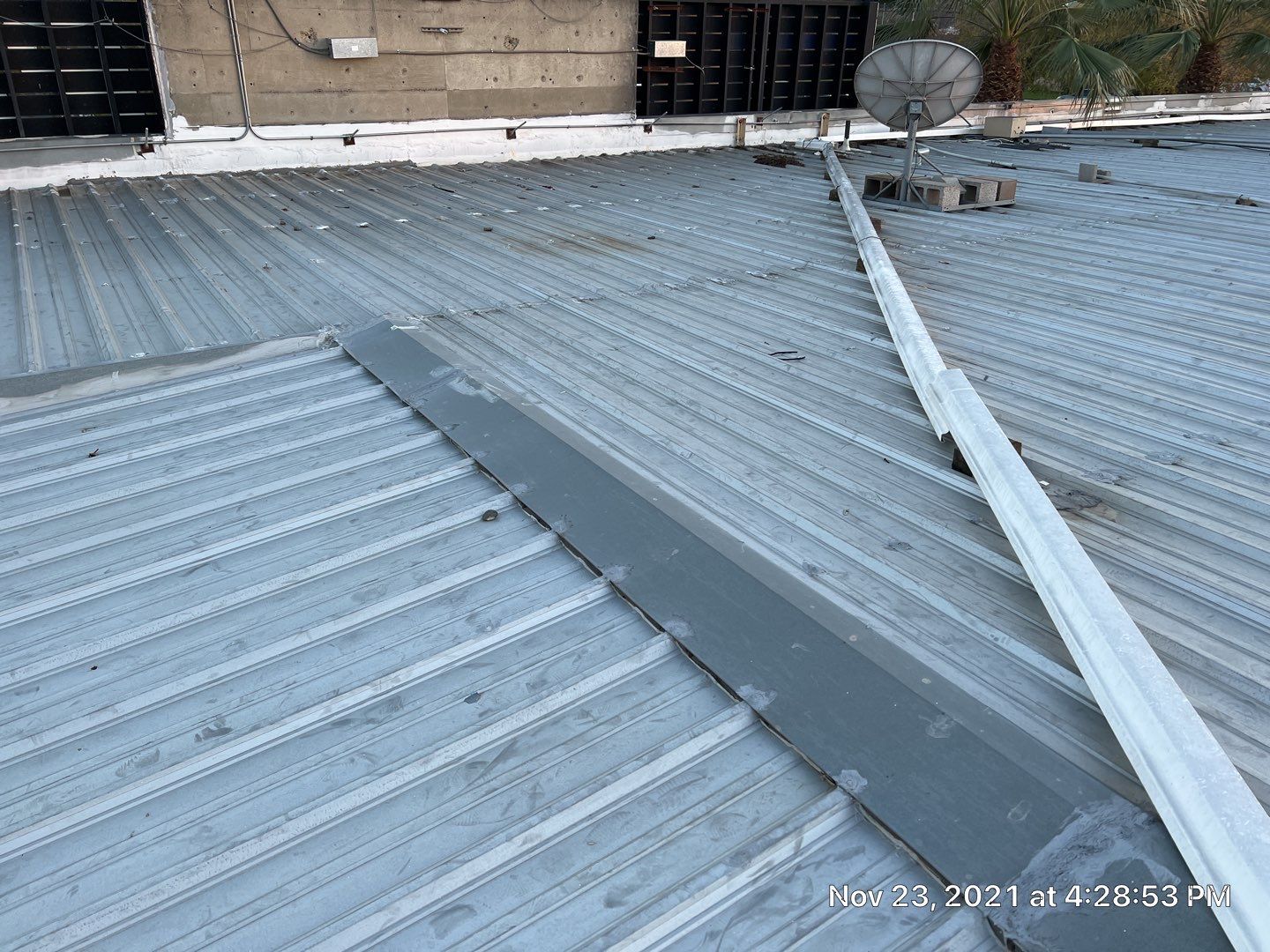 Metal roof restoration on commercial roof using Conklin Benchmark/ PUMA XL acrylic coatings over metal and foam by Straight Edge Roofing Inc