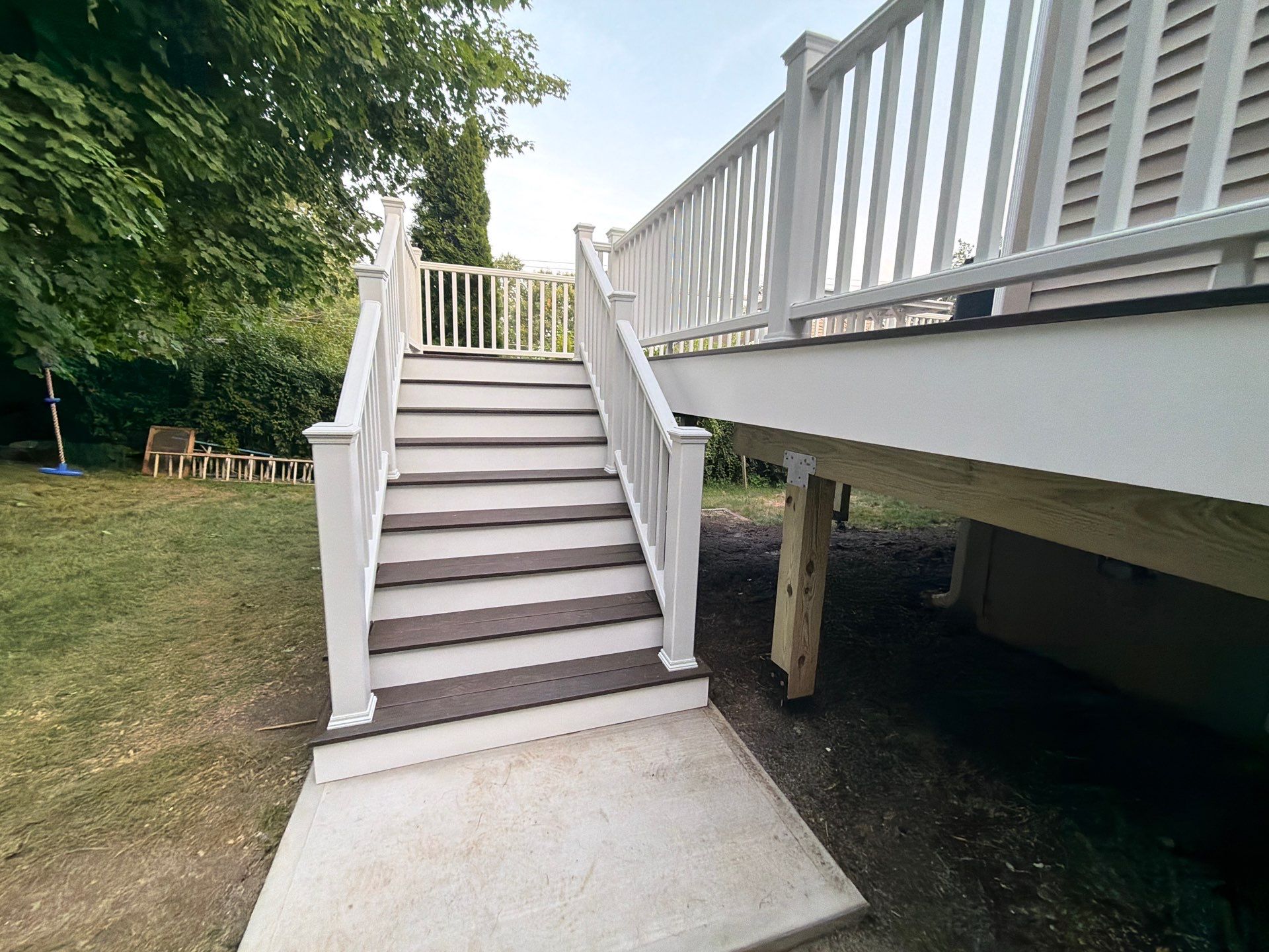 Deck Replacement using Trex Tropical Spiced Rum decking and Transcend White Railing by DiGiorgi Roofing and Siding Inc