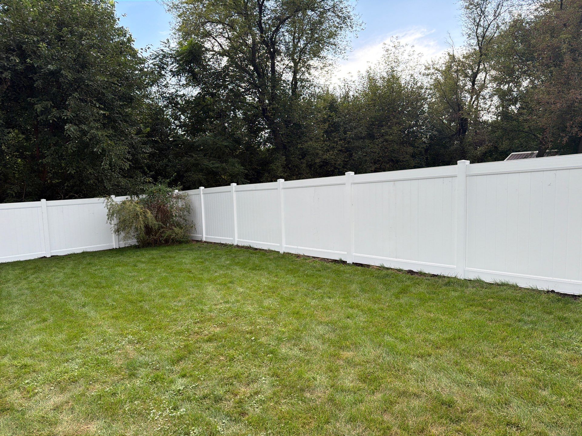 White Vinyl Privacy Fence Installation in Raymond, IA by Perfect Picket Fence and Stain