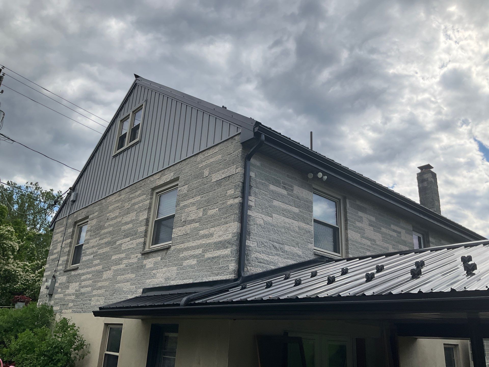 Metal Roofing, Board & Batten Siding, and Entry Door Transformation by Esh Builders